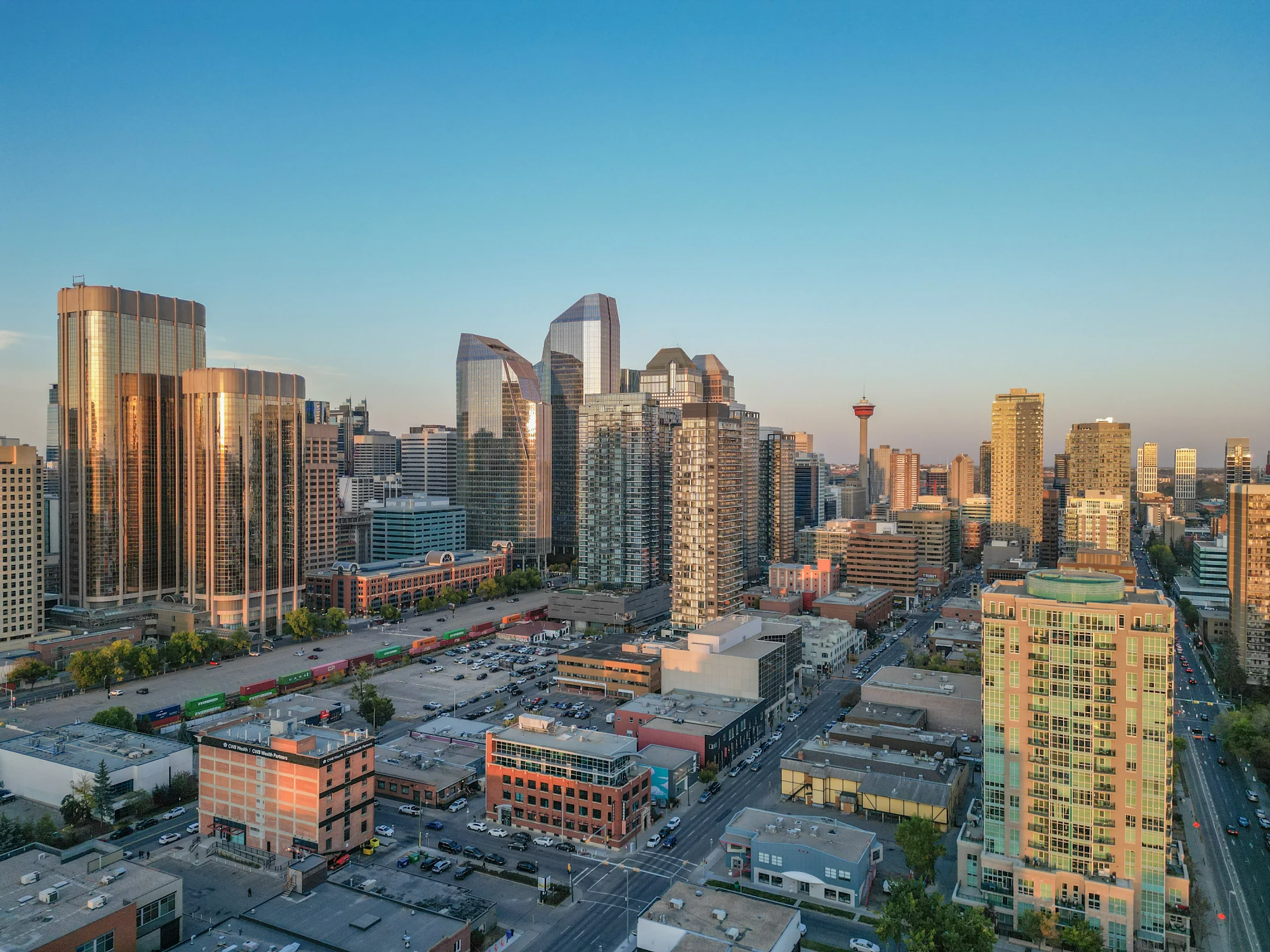 Golden-hour view of downtown condo towers and the Calgary Tower