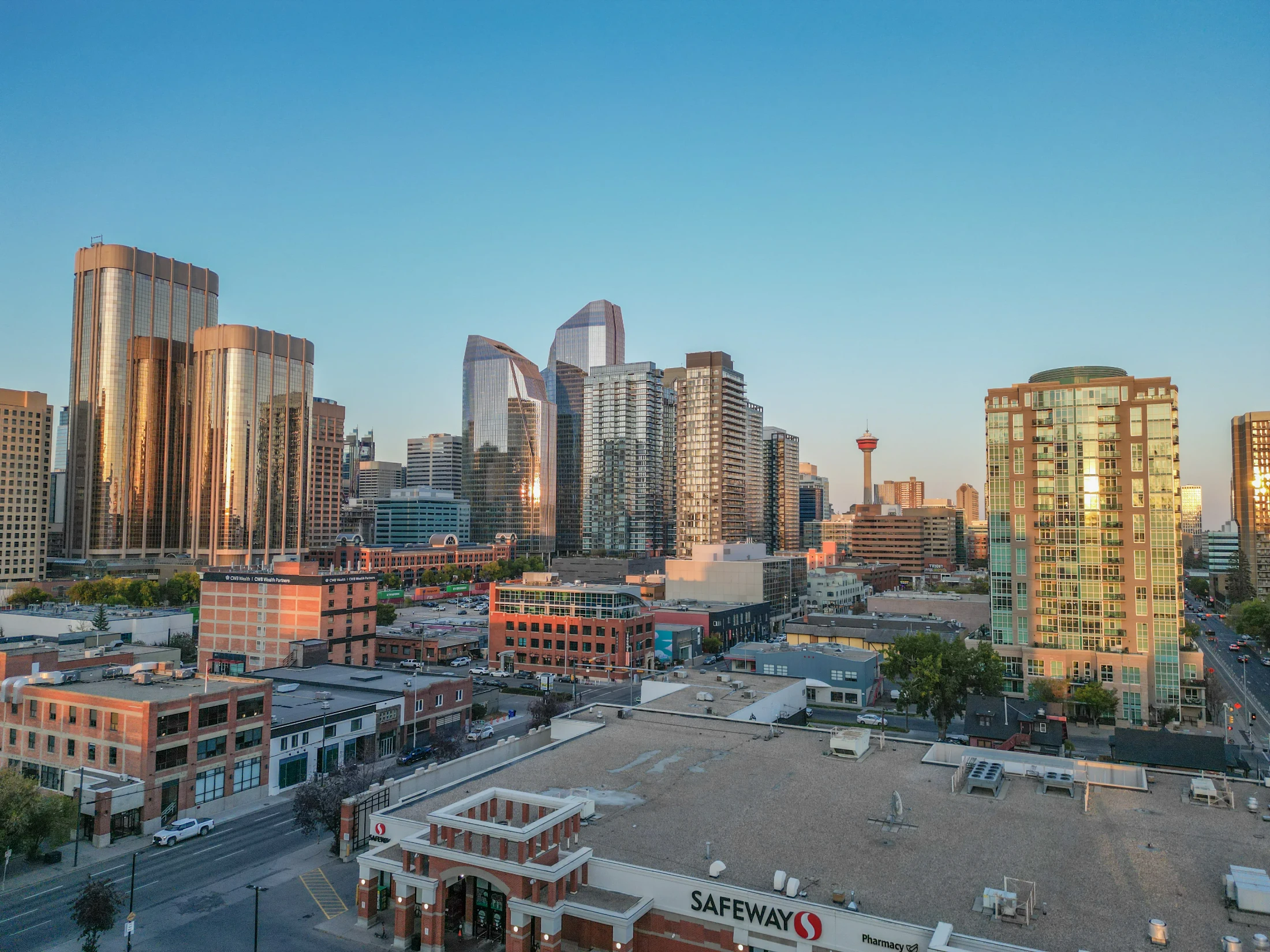 Aerial of brick apartments, trees and downtown towers