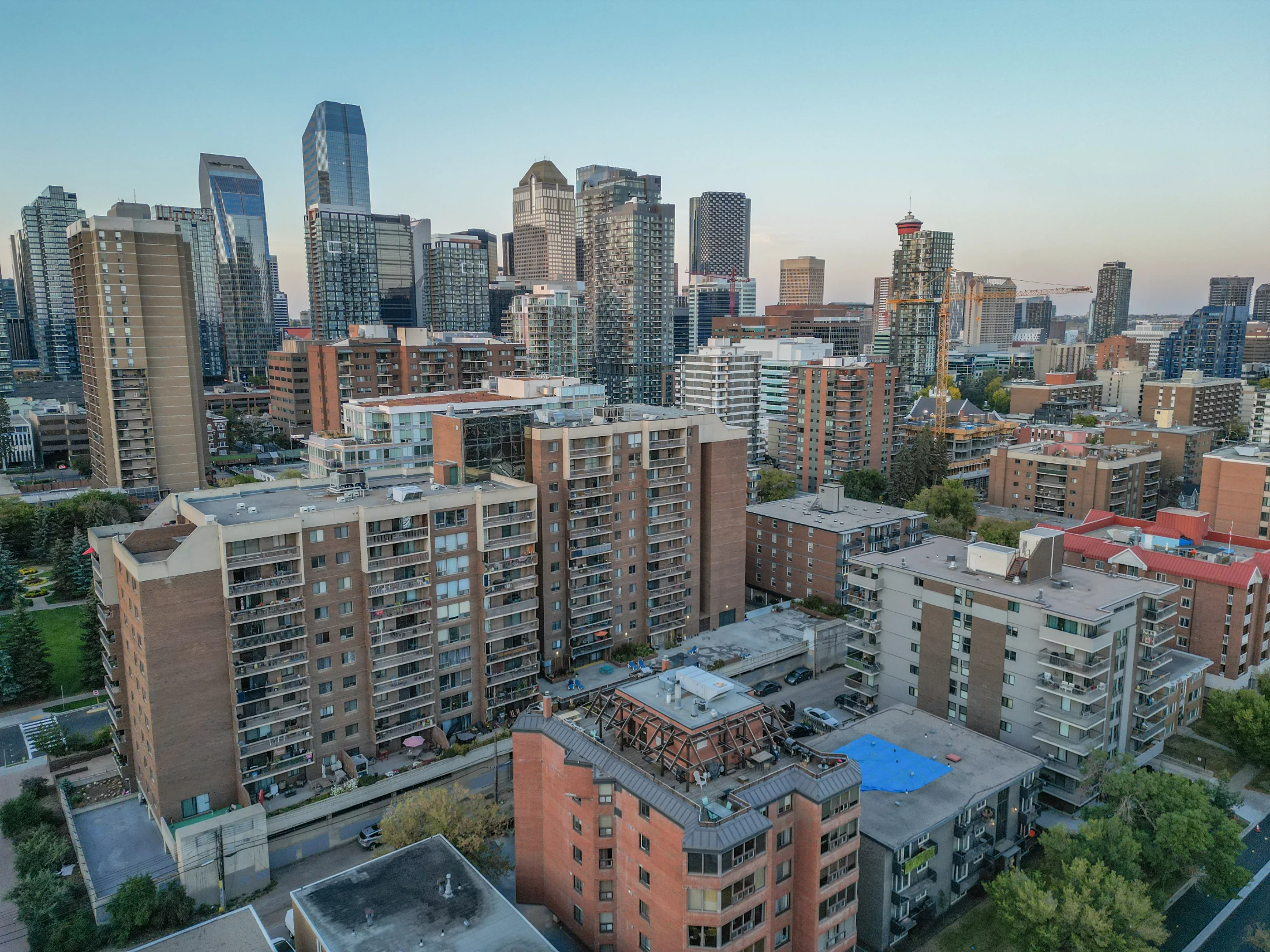 Aerial of brick apartment buildings and condo towers near downtown