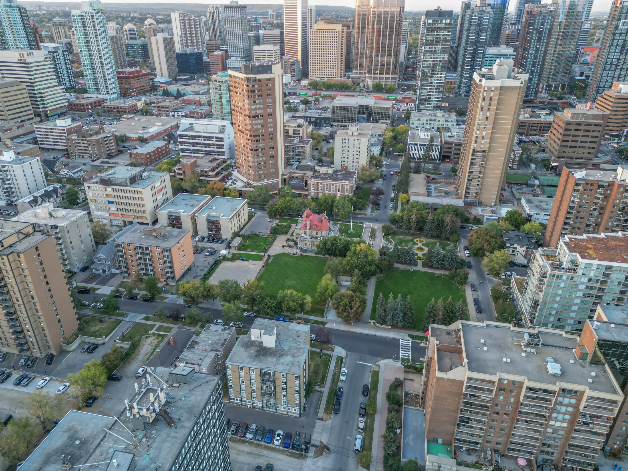 Aerial of older homes and apartments around a green park downtown