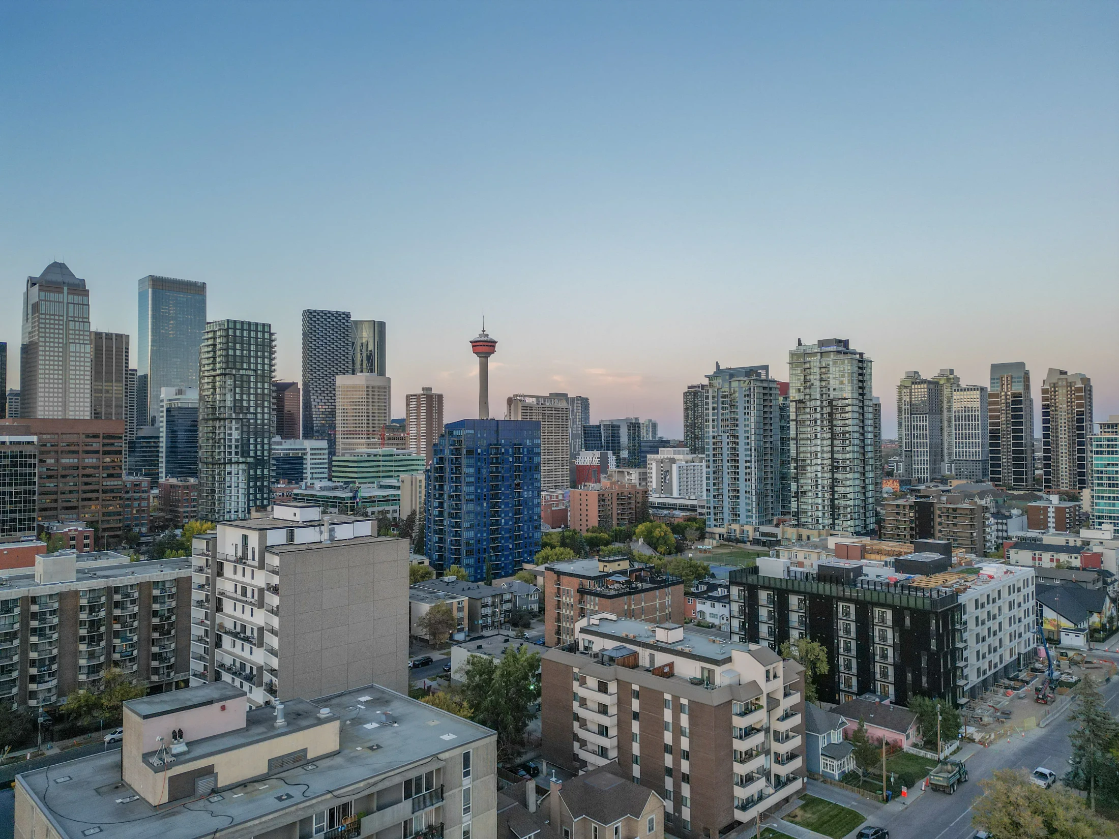 Downtown skyline above inner-city condo buildings at dusk