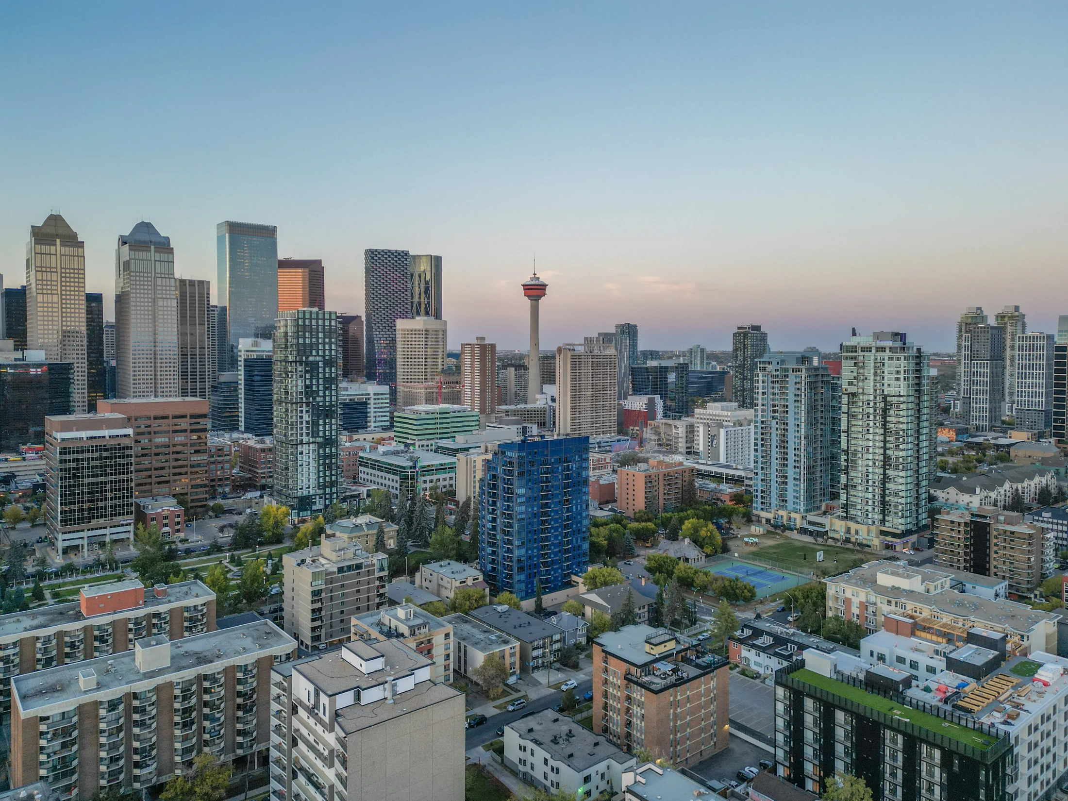 Aerial of high-rise condos and the Calgary Tower at dusk