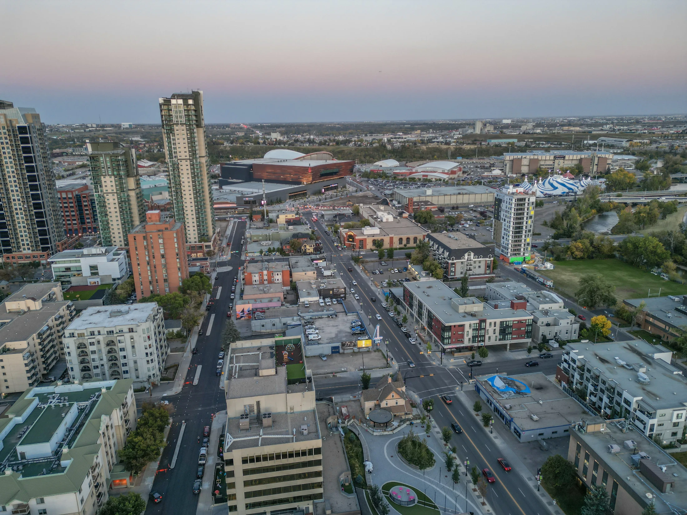 Aerial of inner-city homes and apartments near a large arena