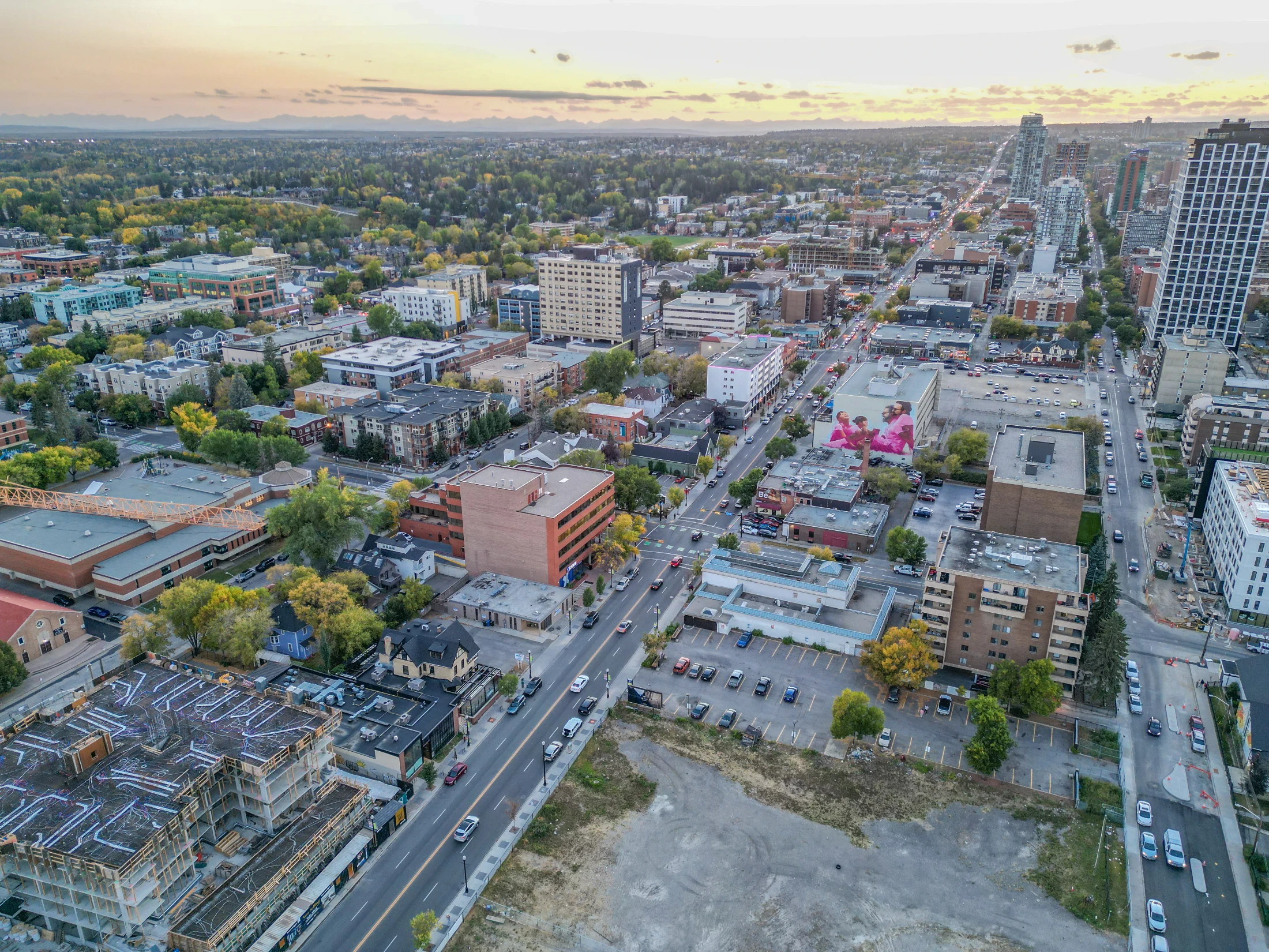 Aerial of an inner-city avenue lined with shops and apartments