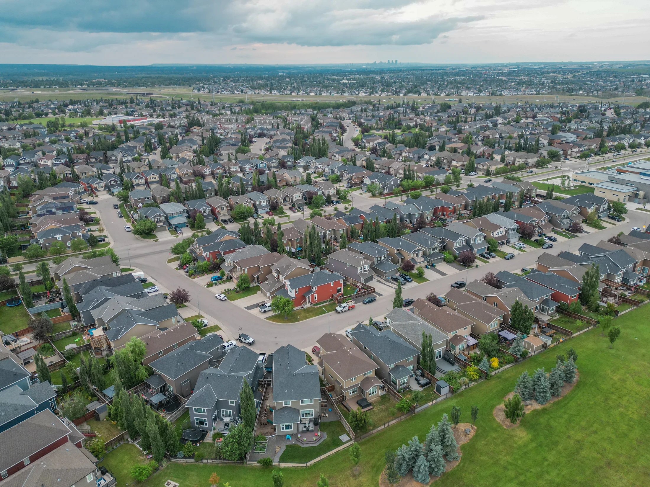 Aerial view of curving streets of detached homes in north Calgary