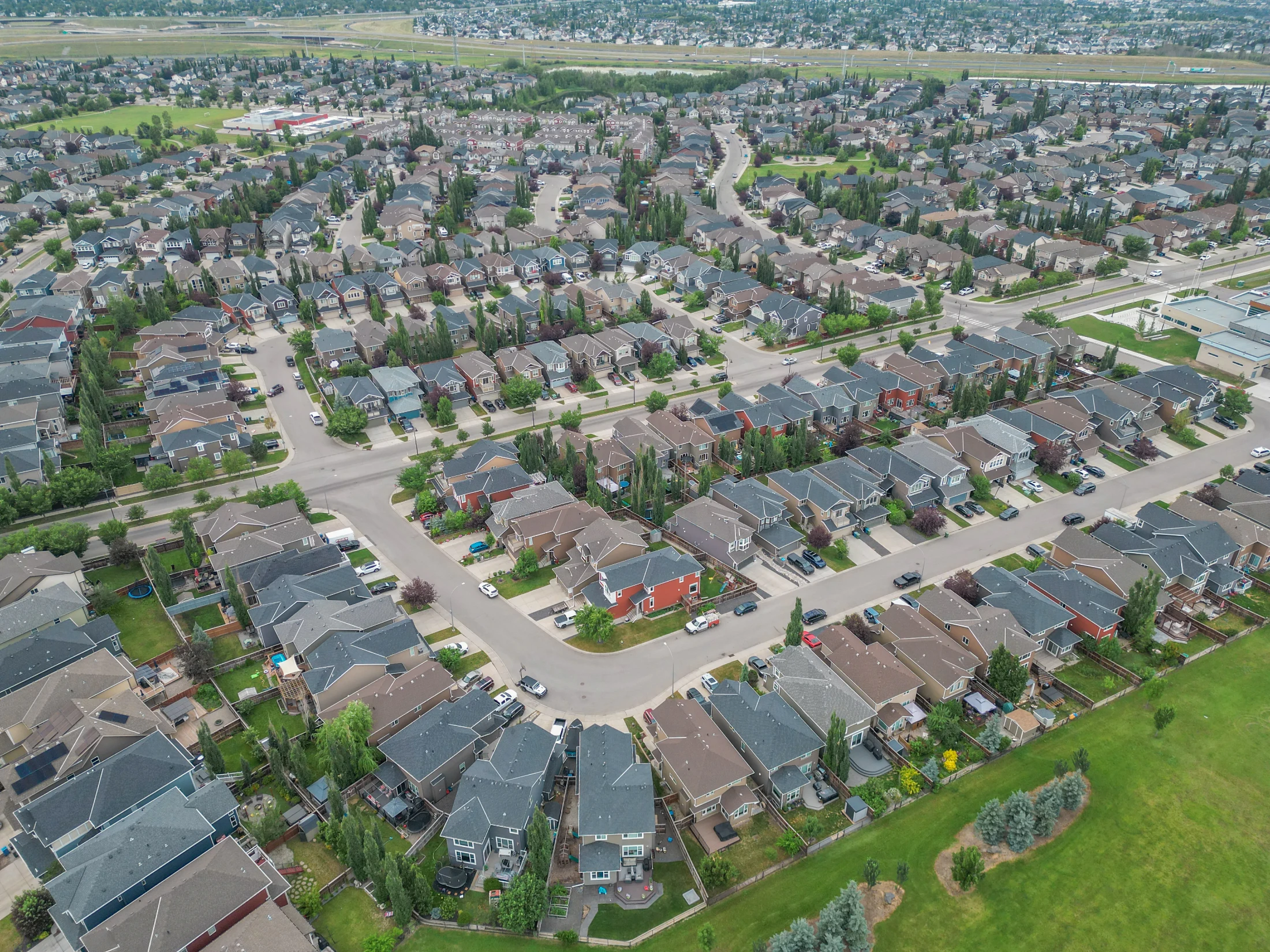 Aerial view of established homes and mature trees in northwest Calgary