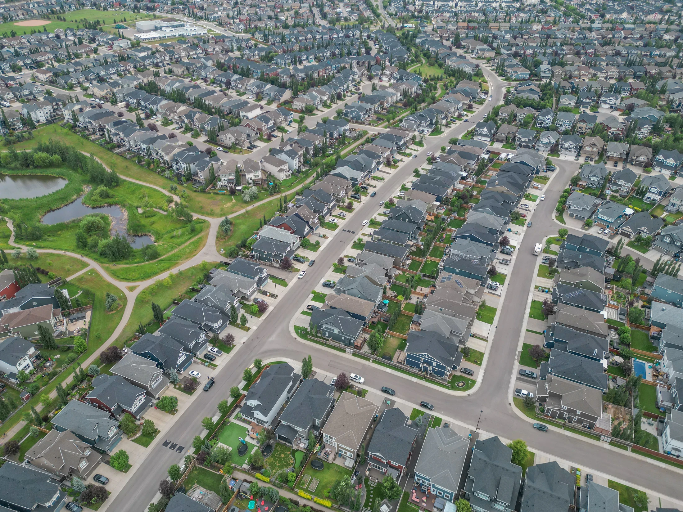 Two-storey family homes along a curving street in northwest Calgary