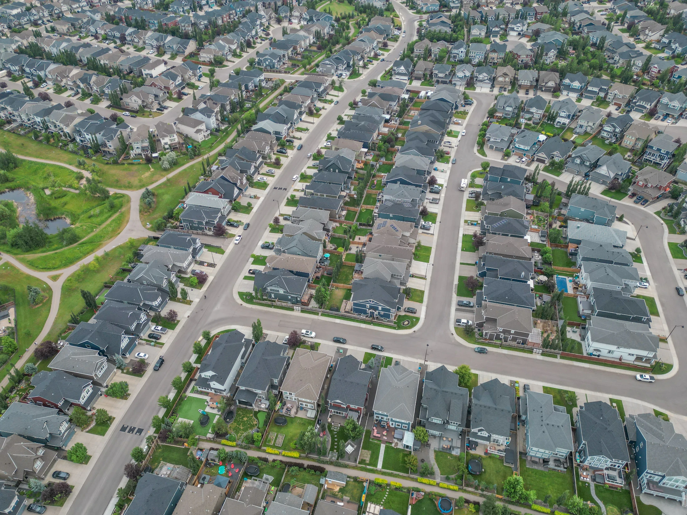 Aerial view of a northwest Calgary suburb with homes around a central green space