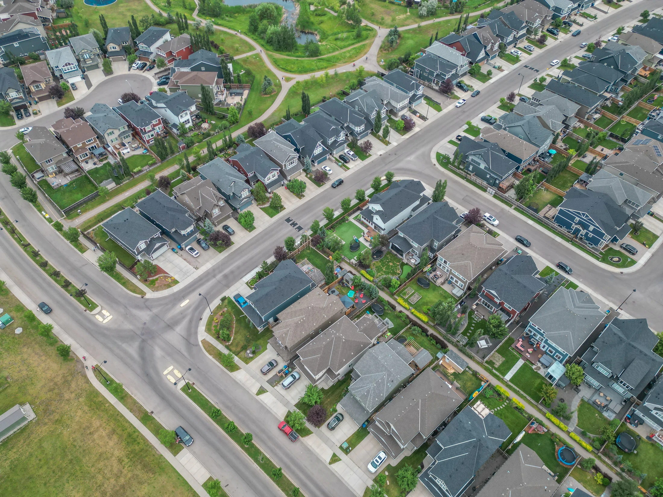 Aerial view of a newer Calgary suburb with detached homes and green space