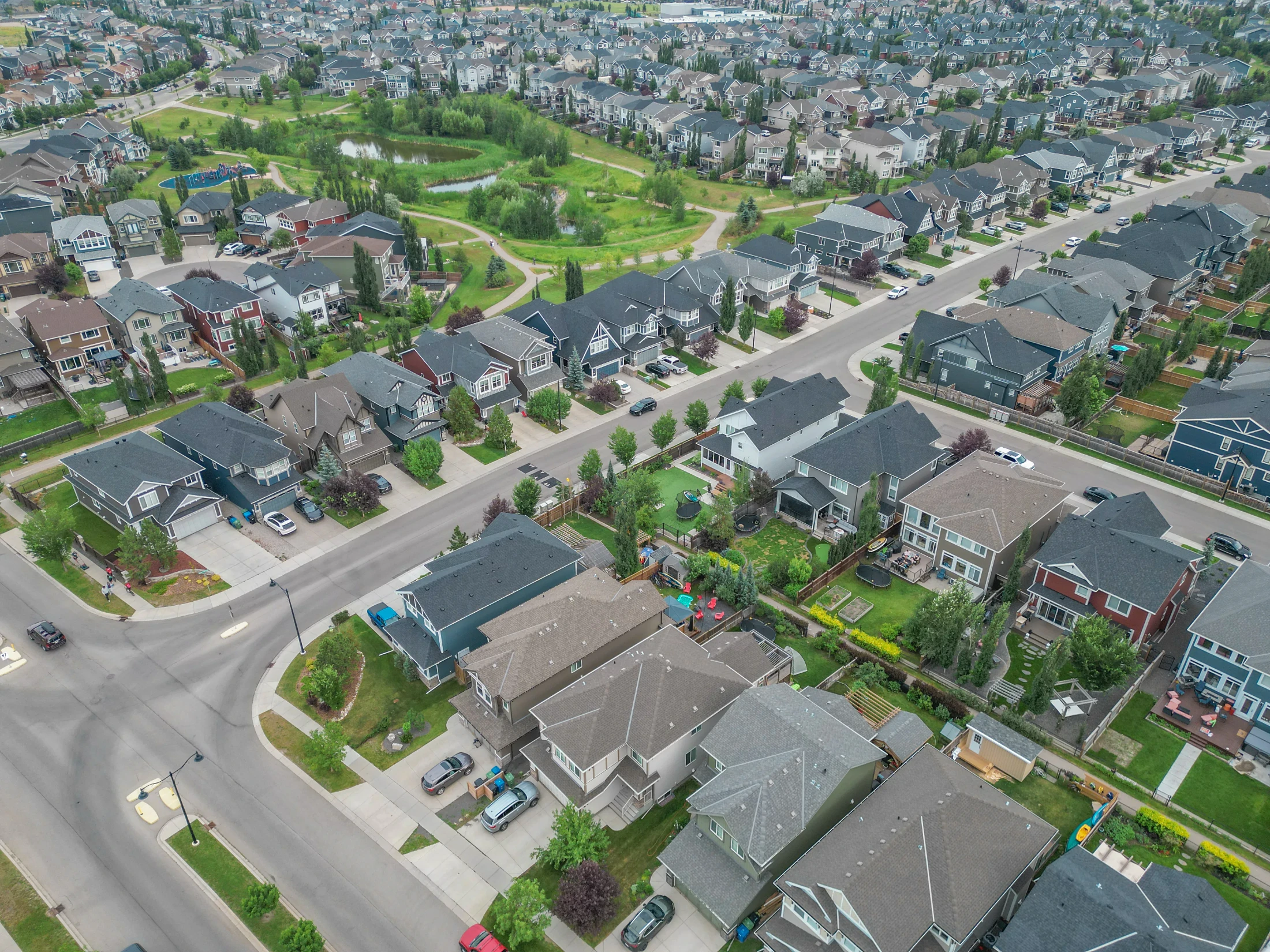 Aerial view of homes, trees and green space in a north Calgary community