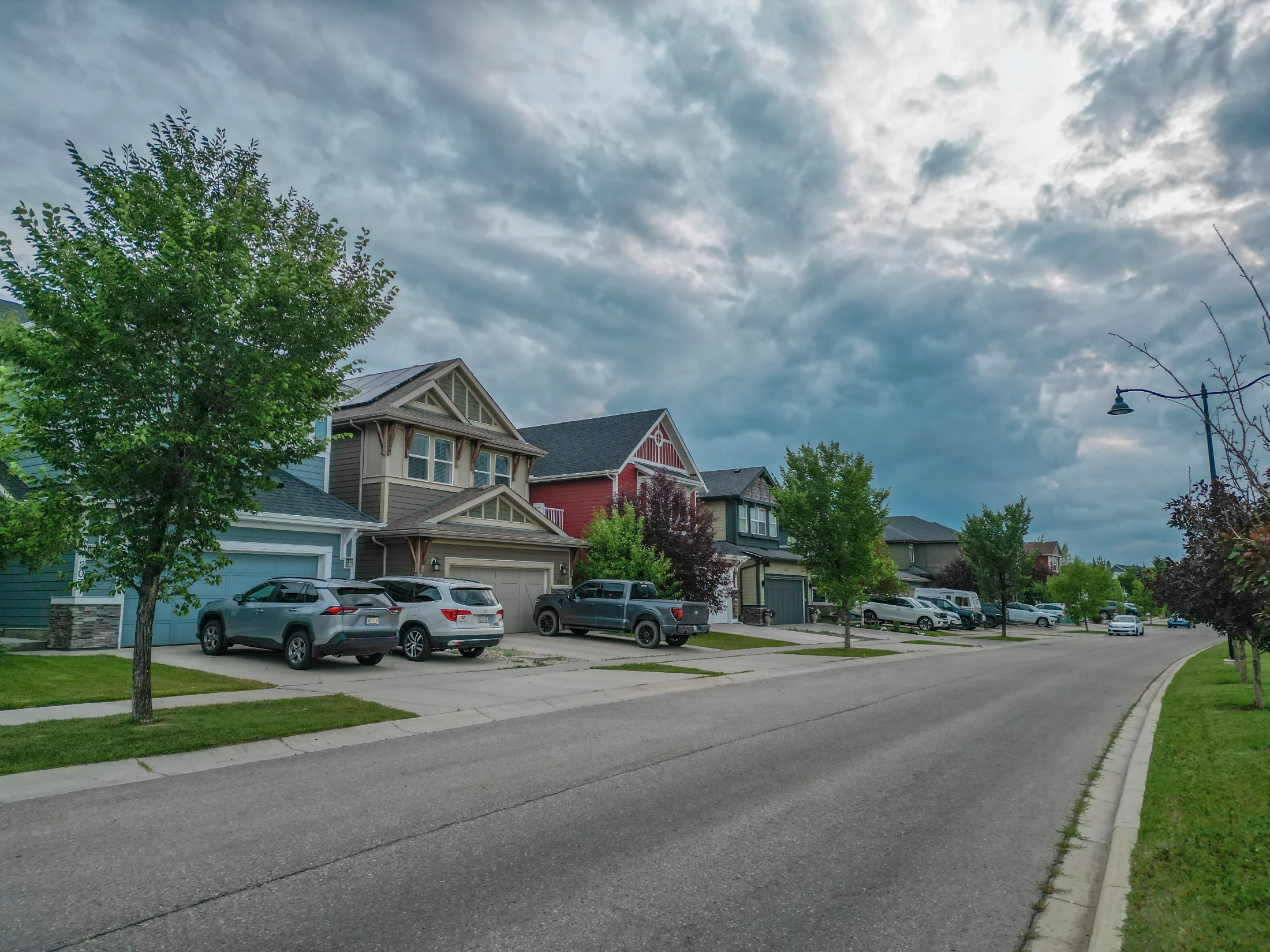 A residential street with townhomes and trees in north Calgary