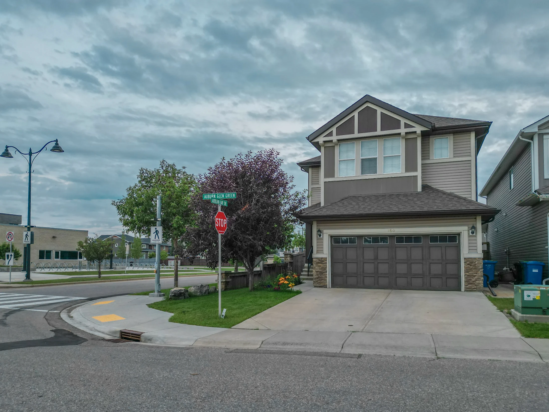 Detached homes on a residential street in Arbour Lake, Calgary