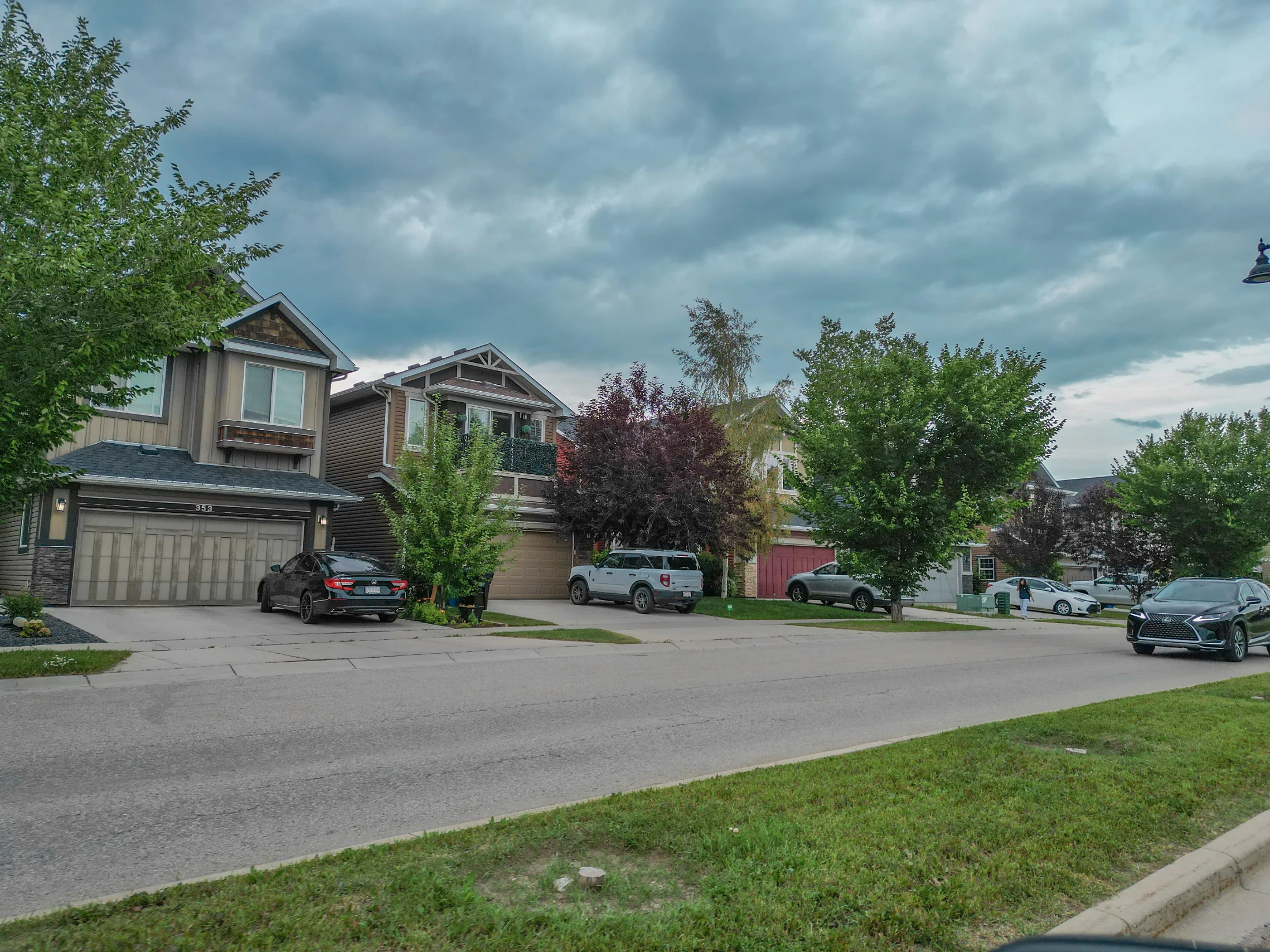 A detached home with a front garage and established trees in northwest Calgary