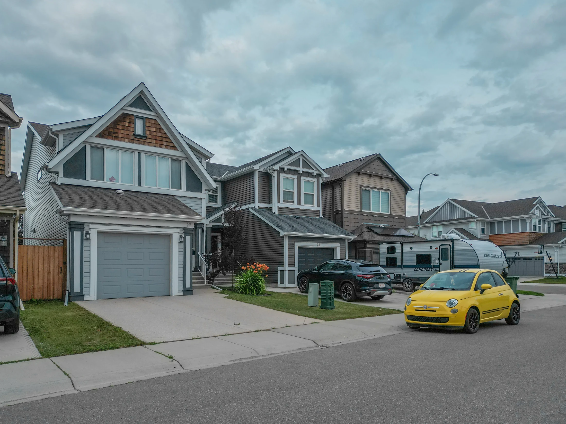 Newer two-storey detached homes with front garages on a north Calgary street