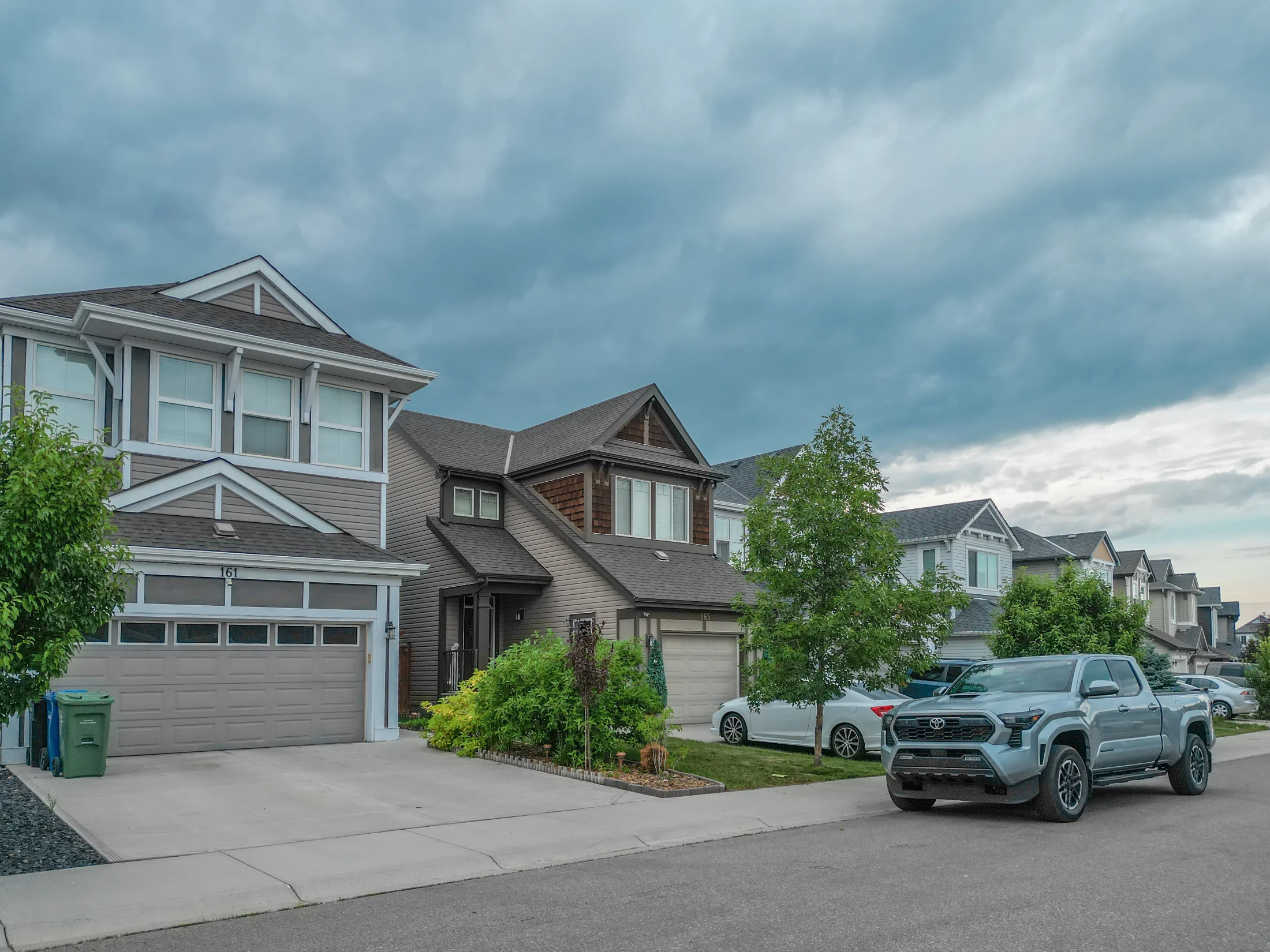 Detached homes with front driveways on a quiet Calgary crescent