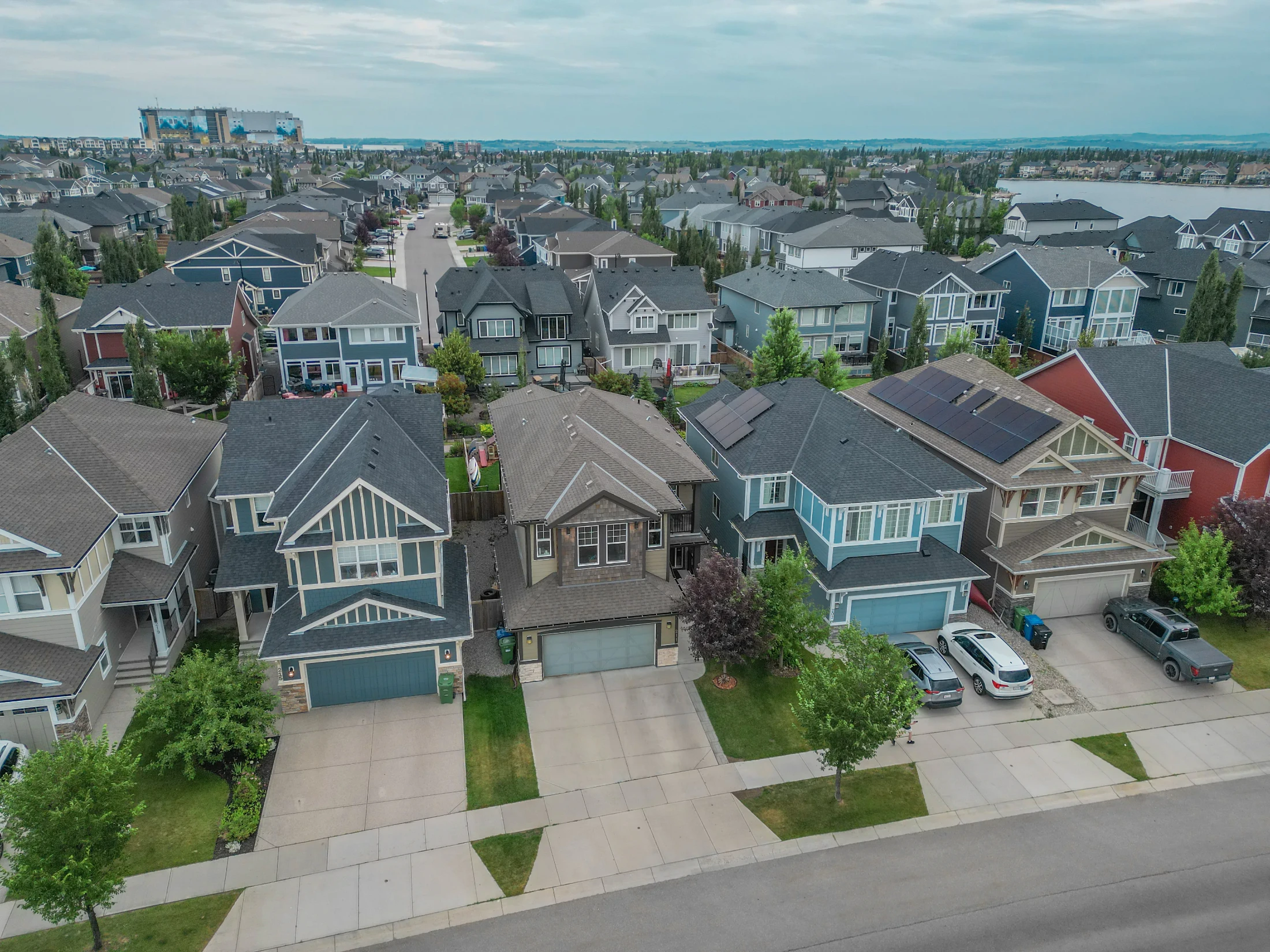 Aerial view of rows of two-storey homes with front garages in a north Calgary suburb