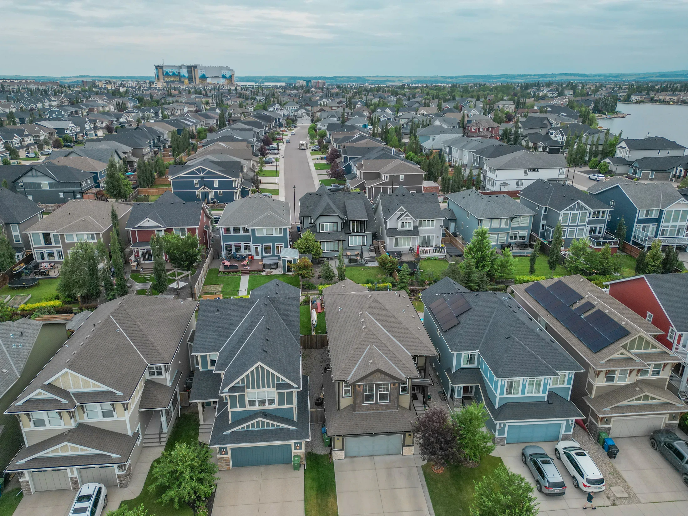 Aerial view of a north Calgary neighbourhood of detached homes and townhomes