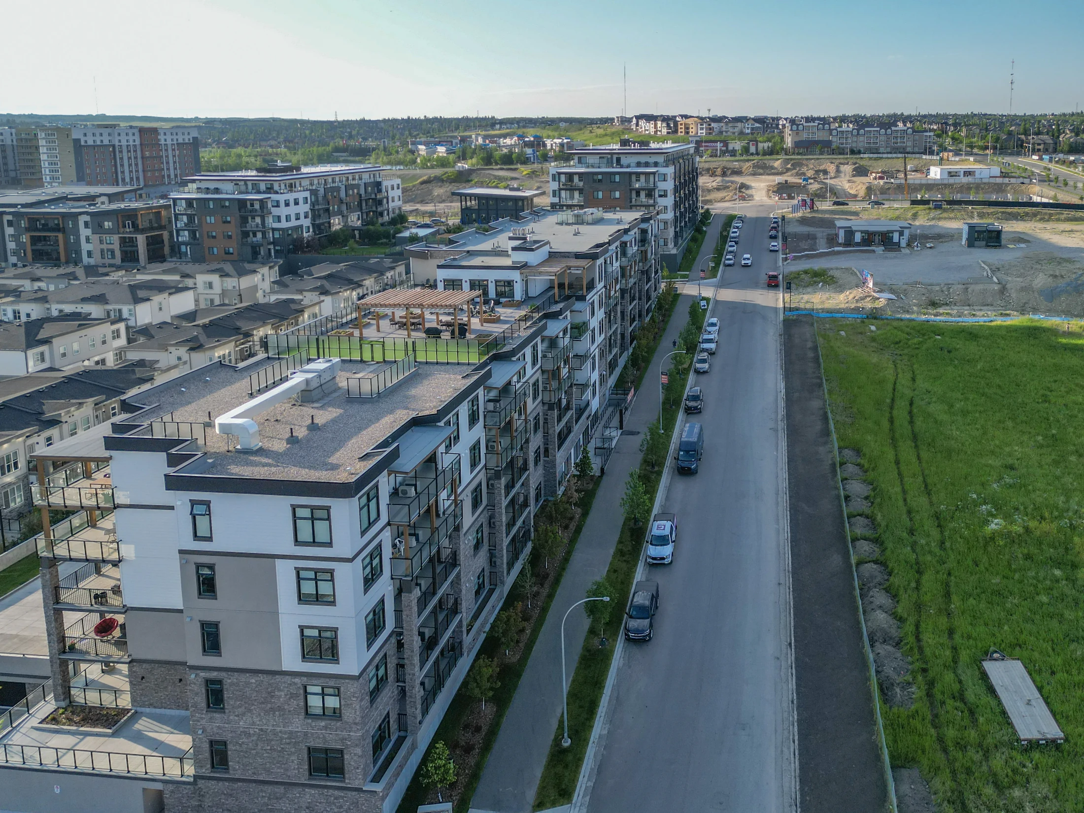 Low-rise condo buildings beside open green space