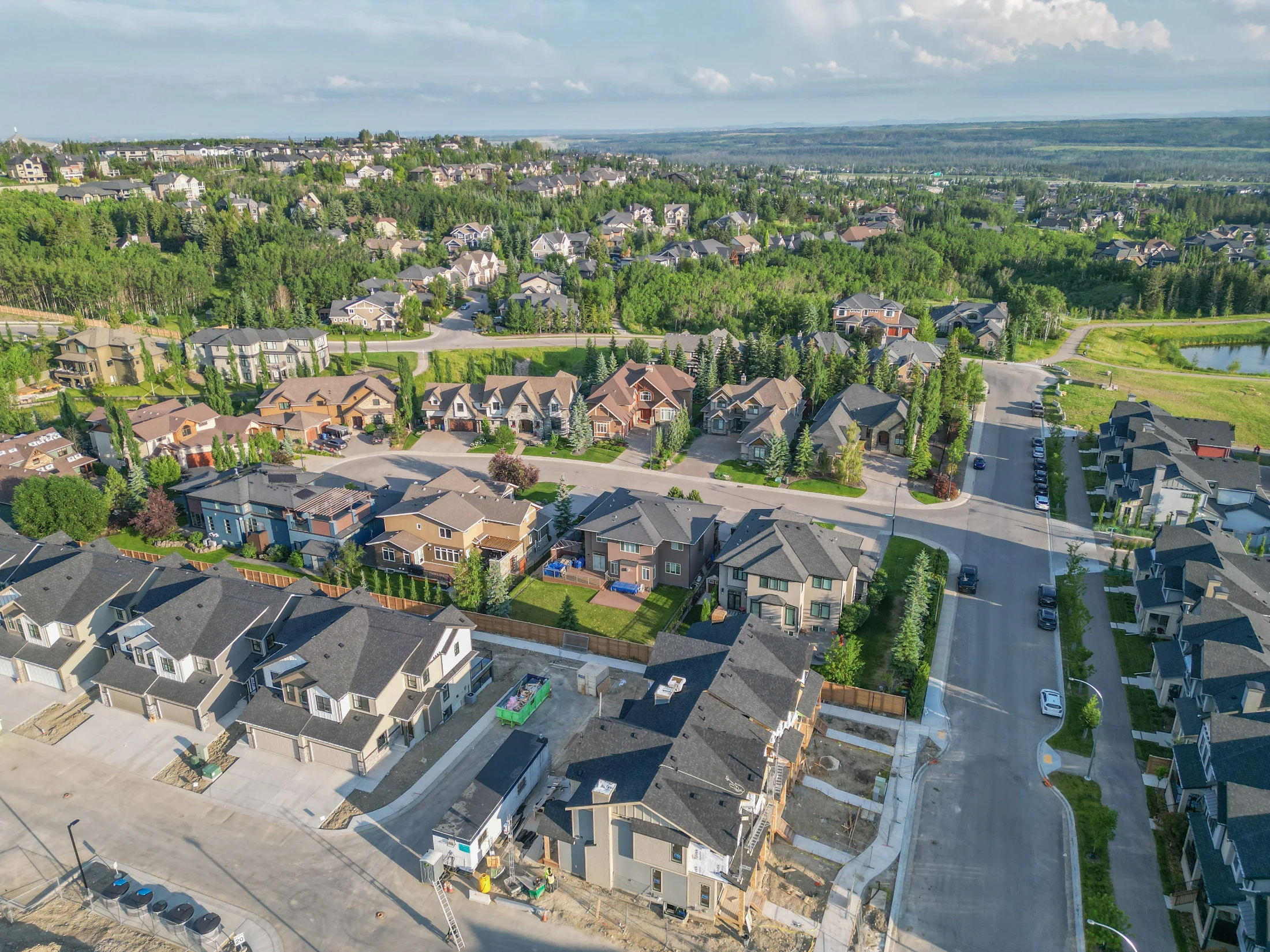 Aerial of estate homes and green space in Aspen Woods, Calgary