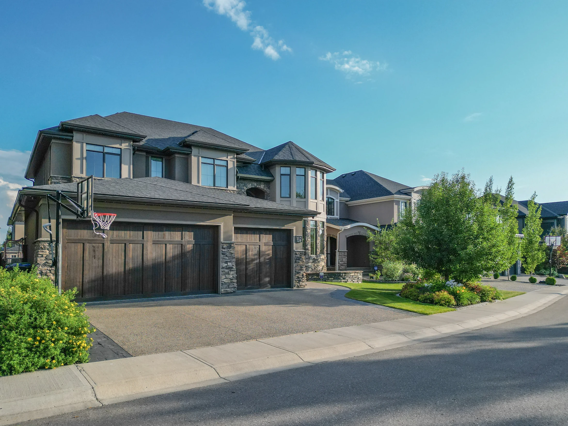 Two-storey estate home with stone accents in Aspen Woods, Calgary
