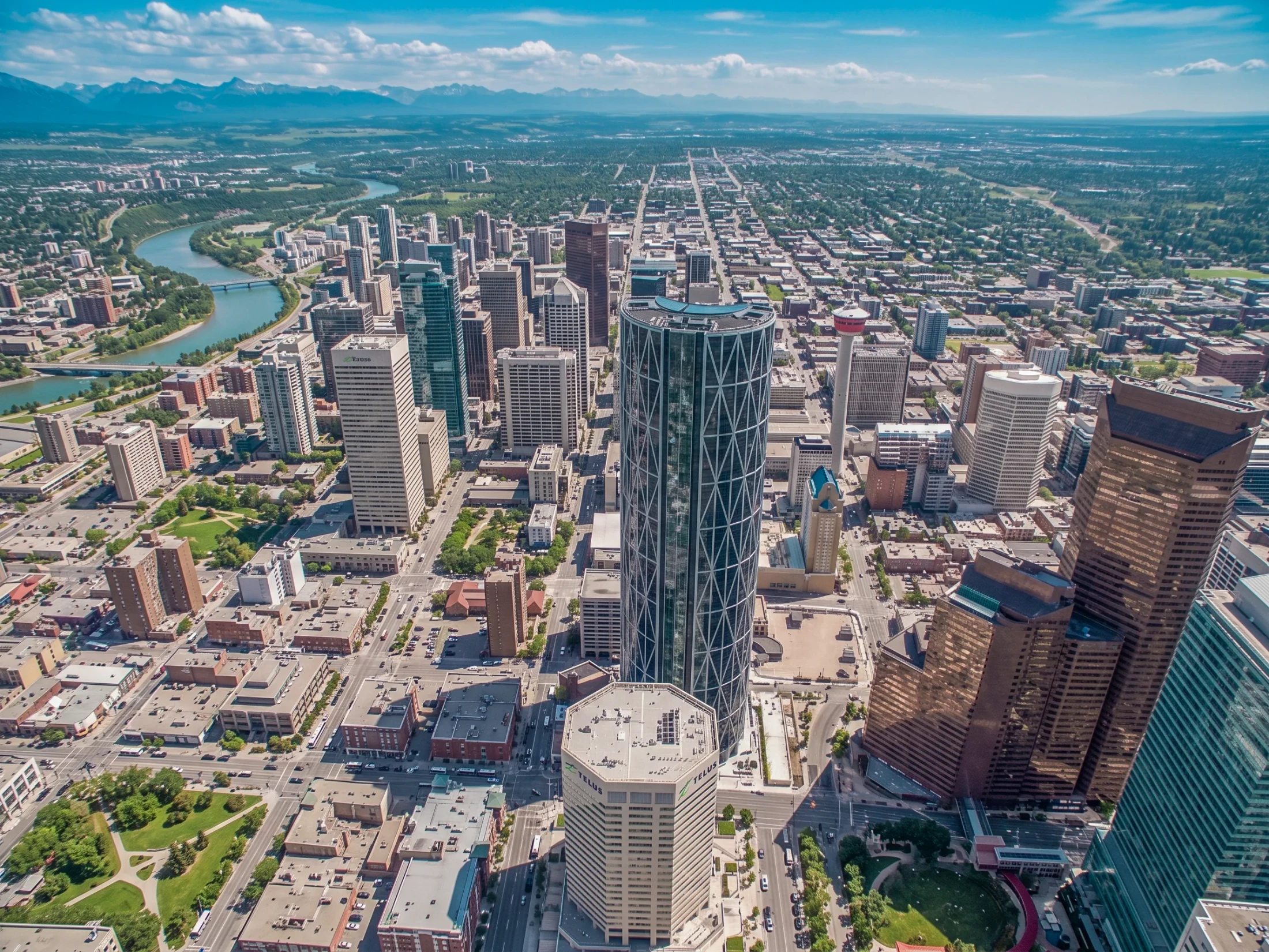 Aerial of downtown Calgary towers with the Bow River in the distance