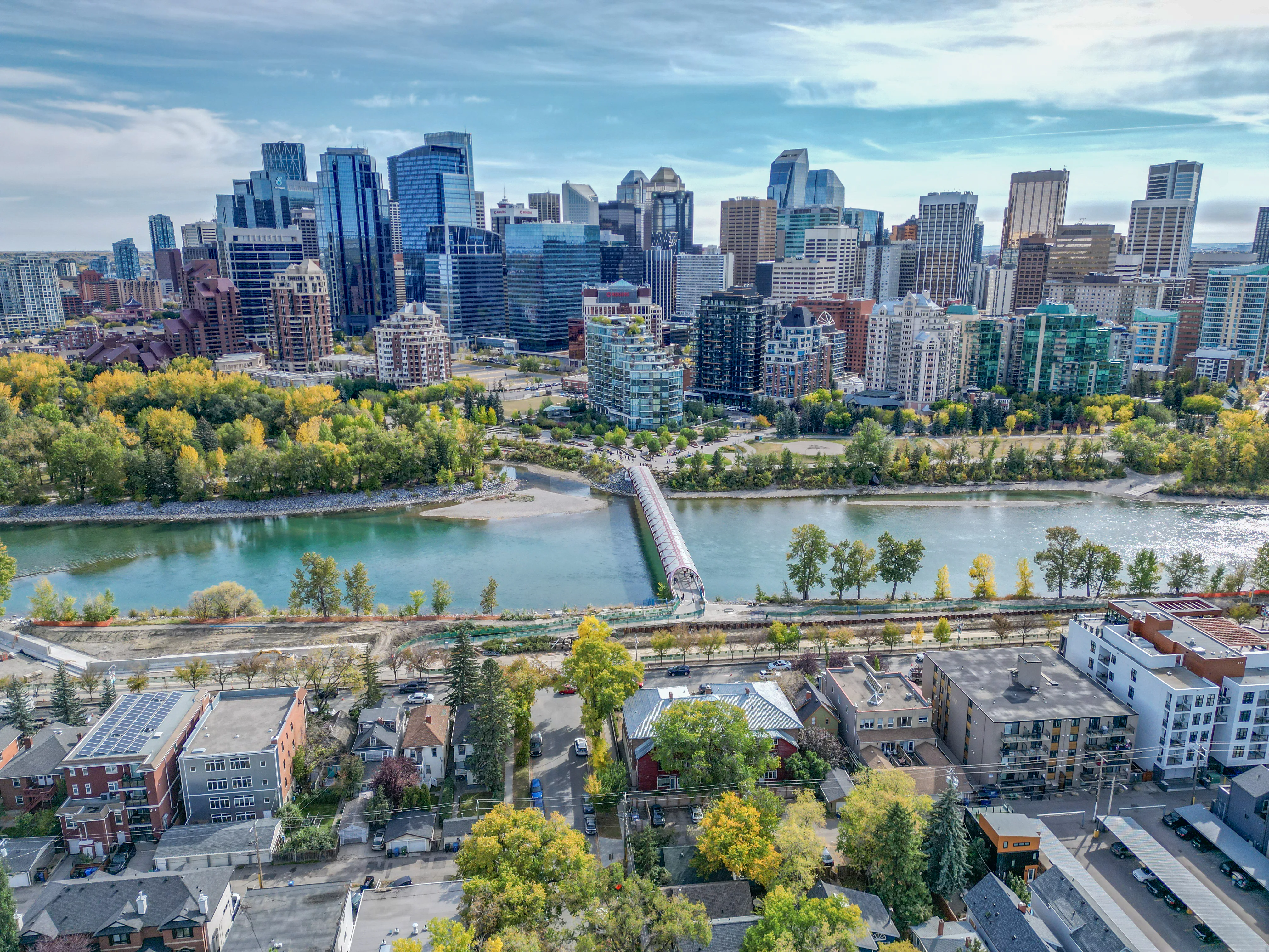Bow River and parkland below a dense downtown skyline