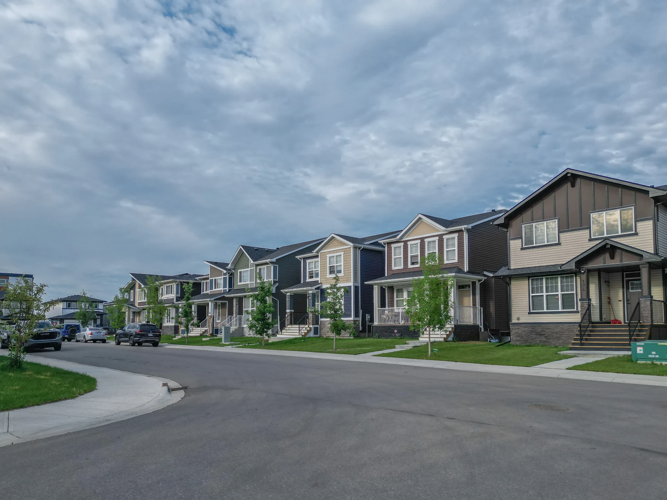 Street of new two-storey homes with front garages and young trees