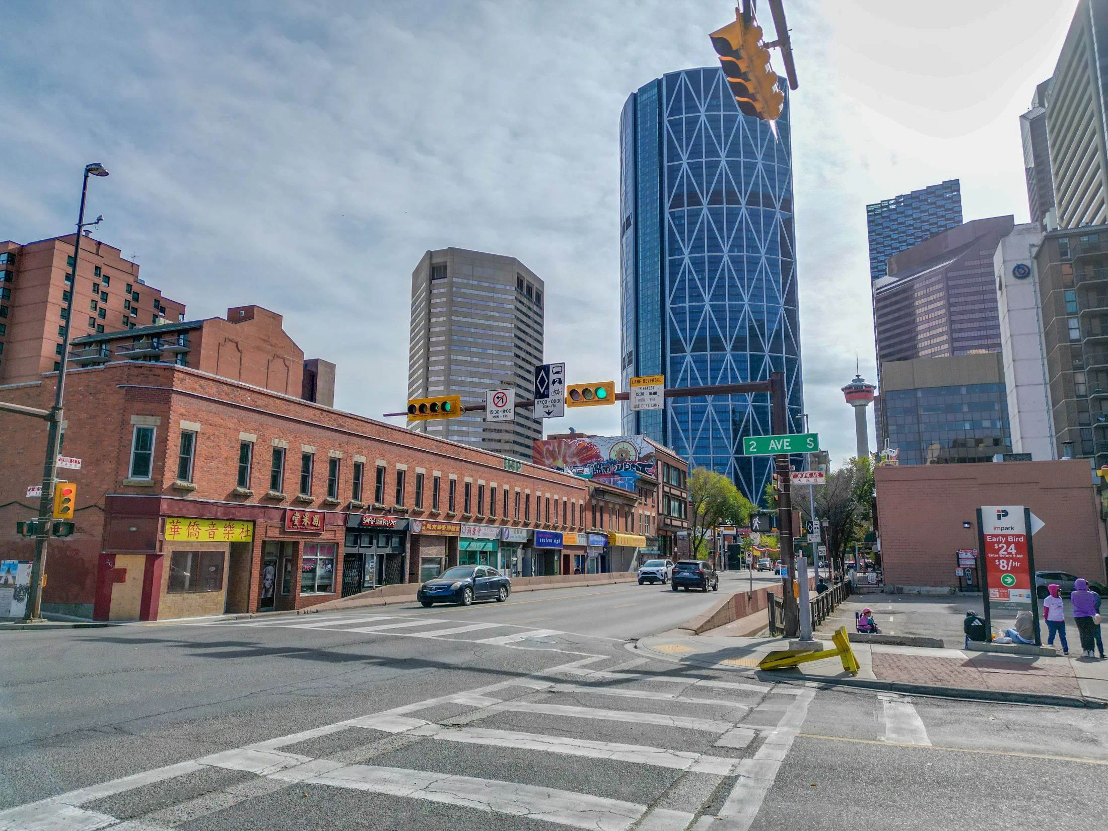 Low-rise brick shops in Calgary's Chinatown with downtown towers behind