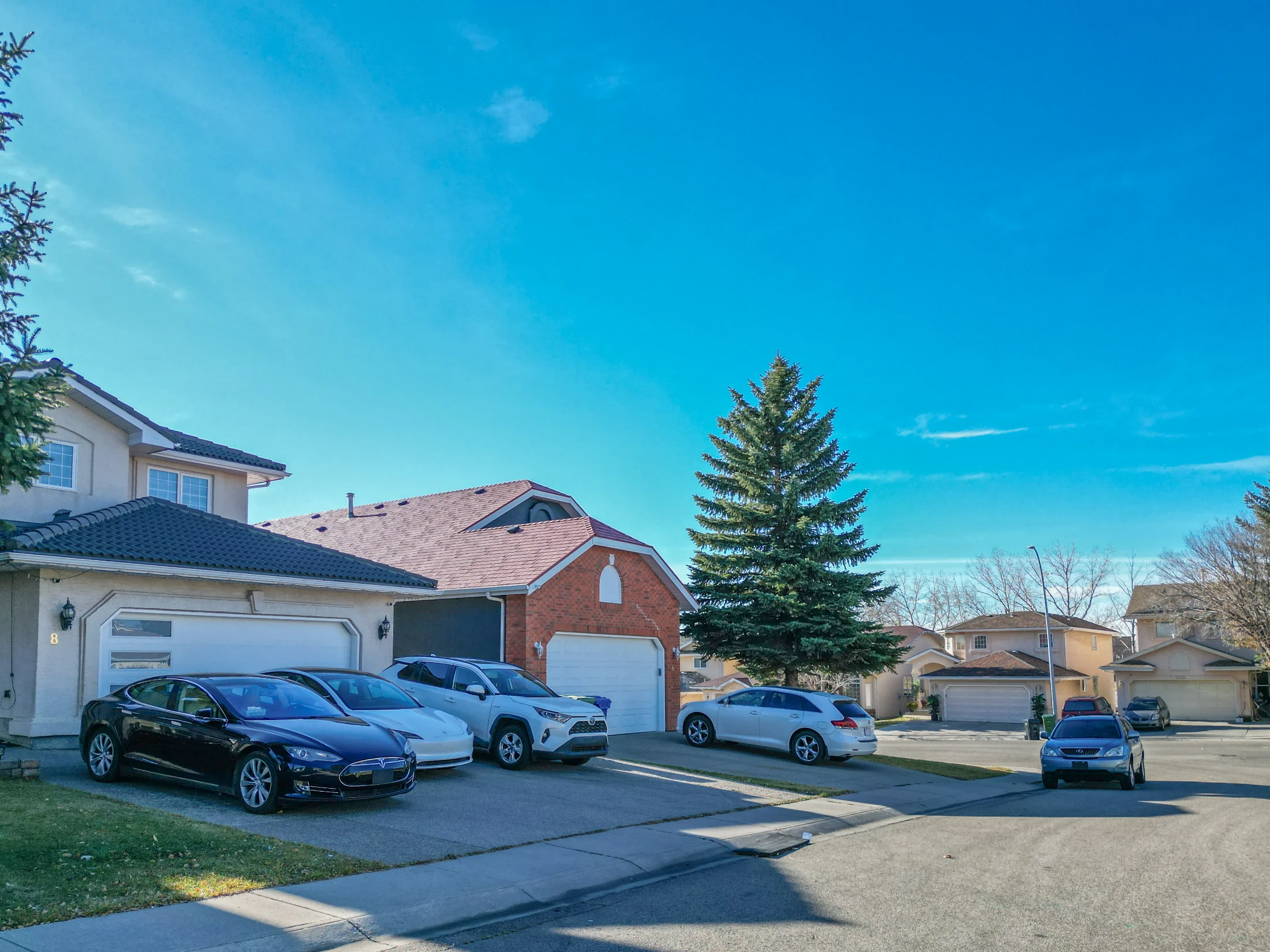 Two-storey homes with vehicles in the driveways