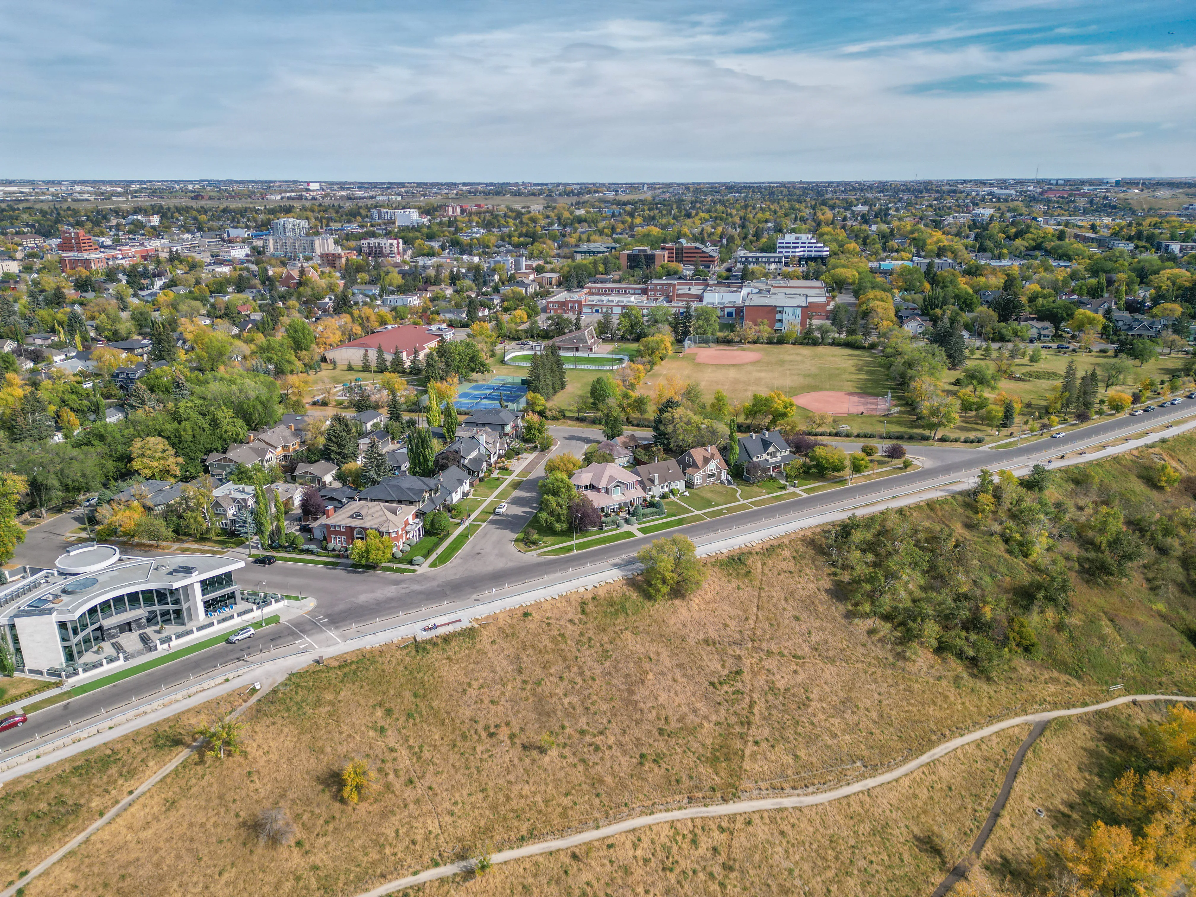 Hilltop park with grass, trees and a winding path