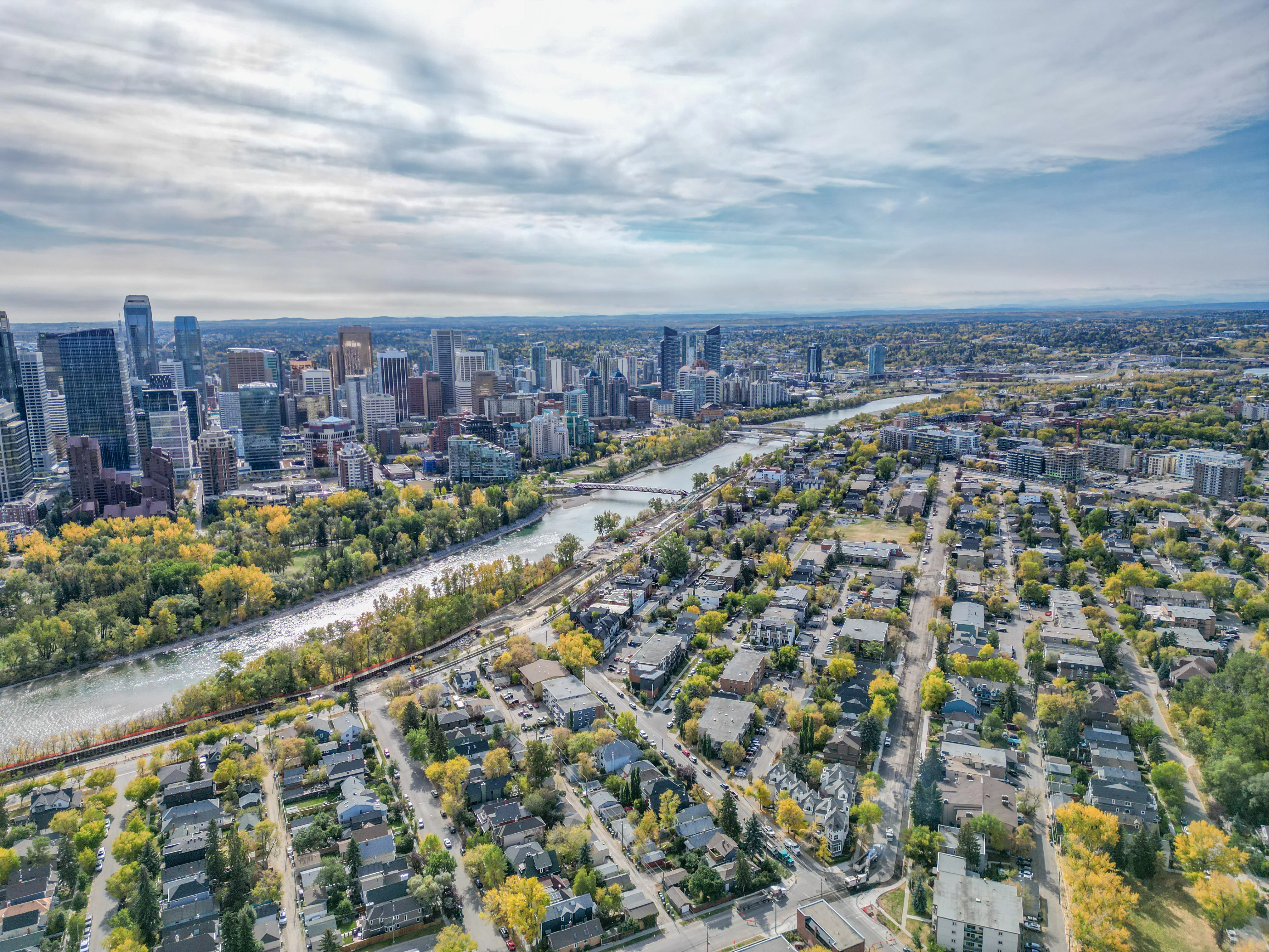 Aerial view of Crescent Heights, Calgary, with mature trees, the Bow River and the downtown skyline