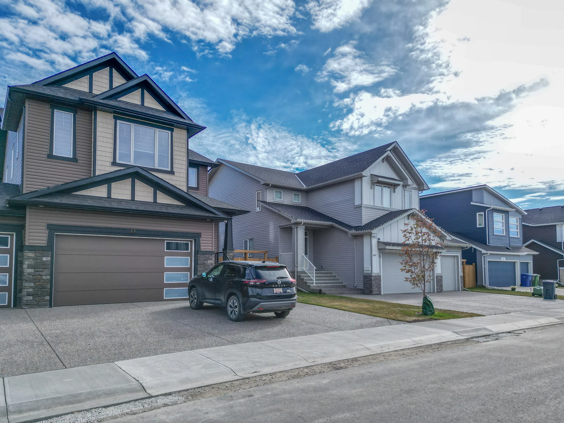 Newer two-storey homes with stone accents and front driveways