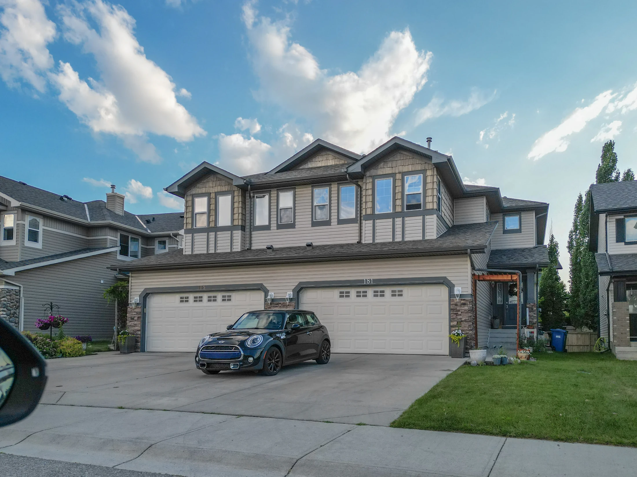 Two-storey homes with front-drive garages on a suburban street