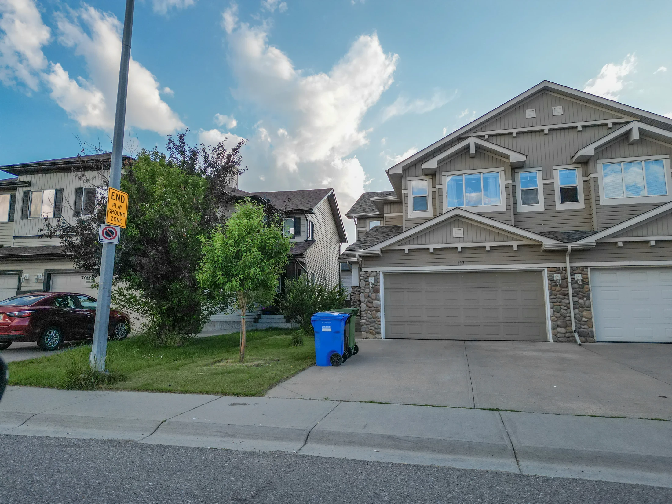 Newer two-storey homes with front garages on a suburban street