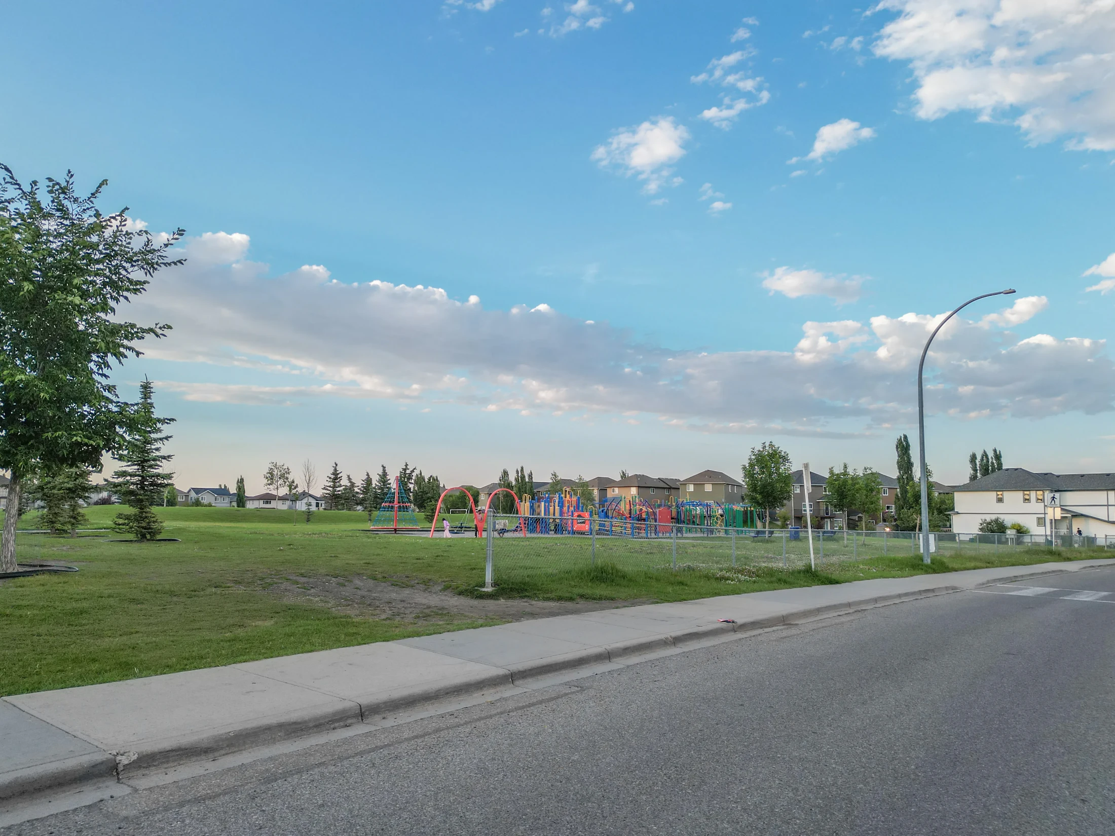Park and playground beside a residential street