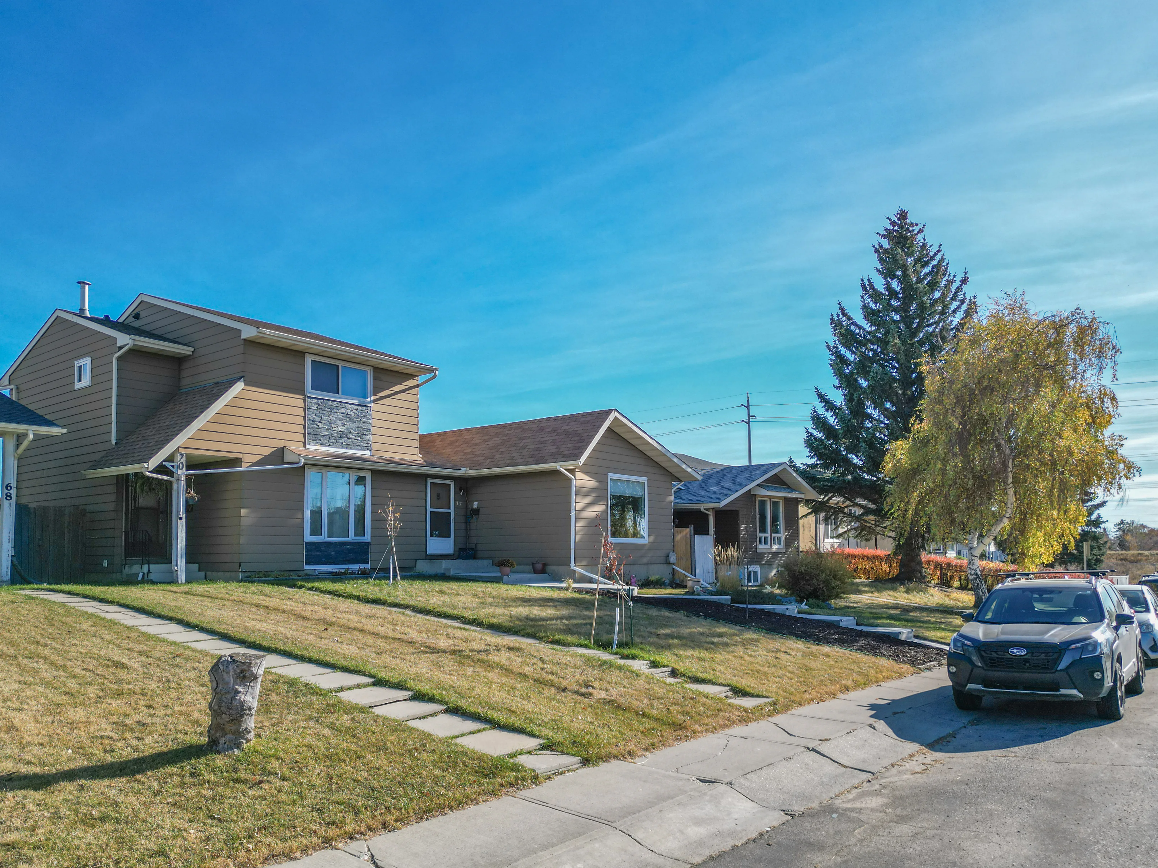 Two-storey home and bungalow with mature trees