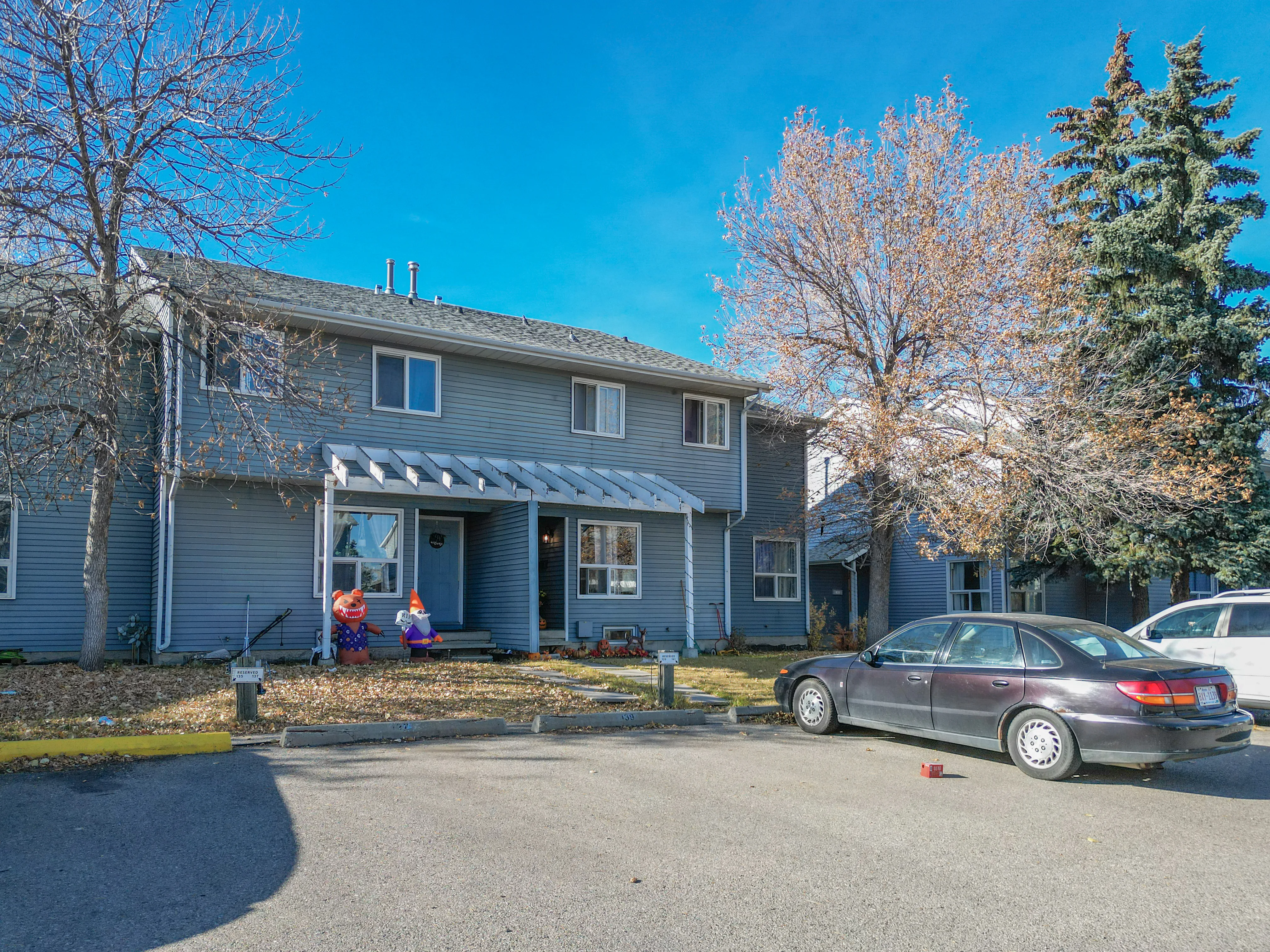Two-storey townhome complex with parking in front