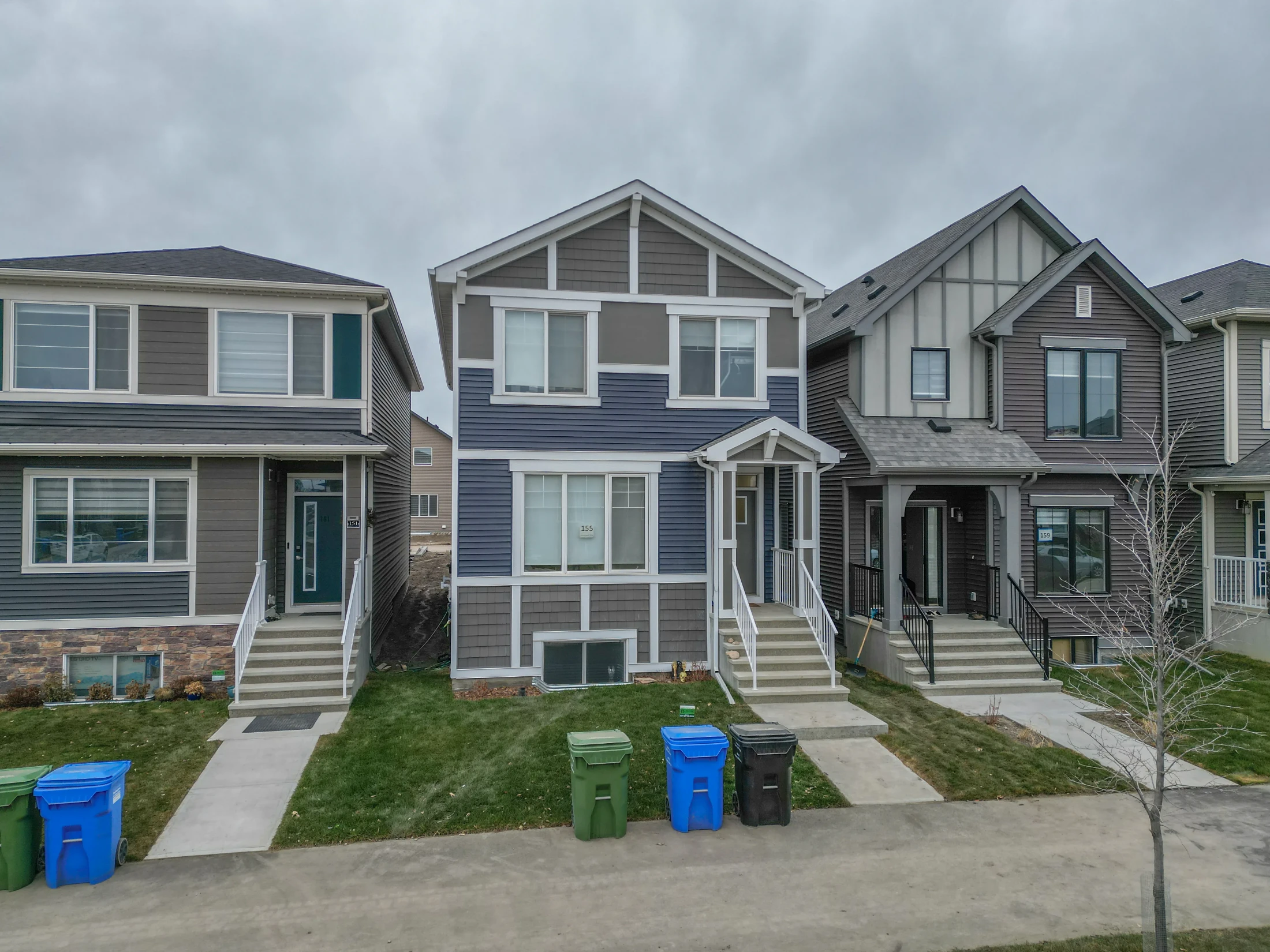 New two-storey homes with front steps and small lawns