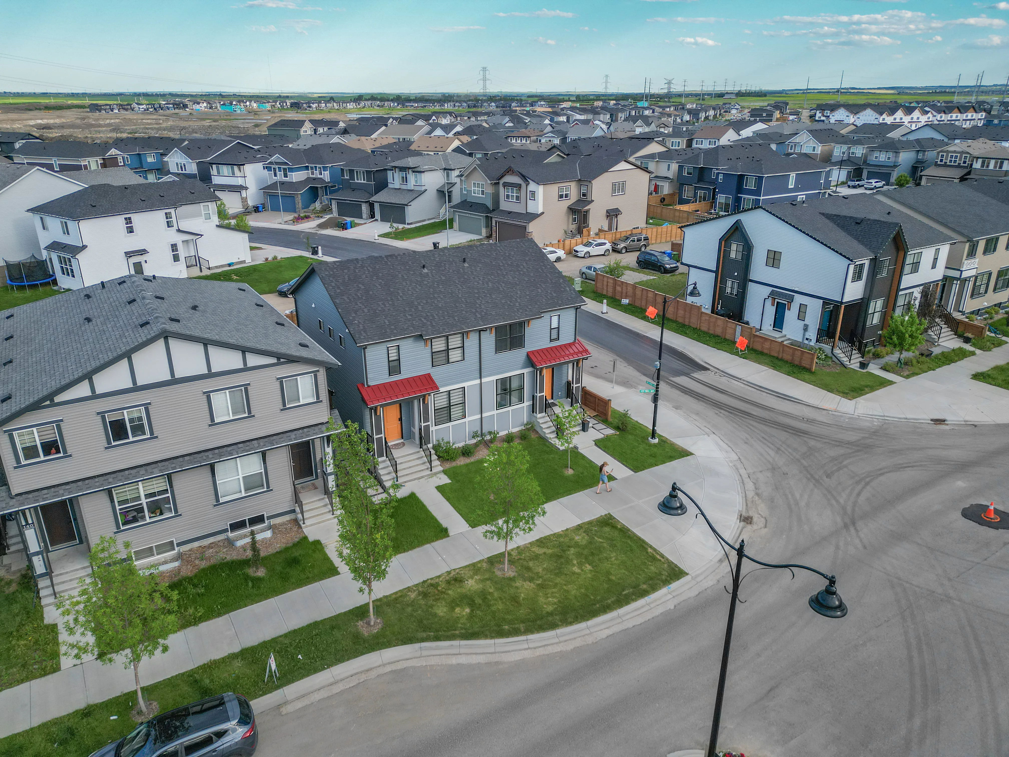 Aerial of new two-storey homes on a corner with young trees