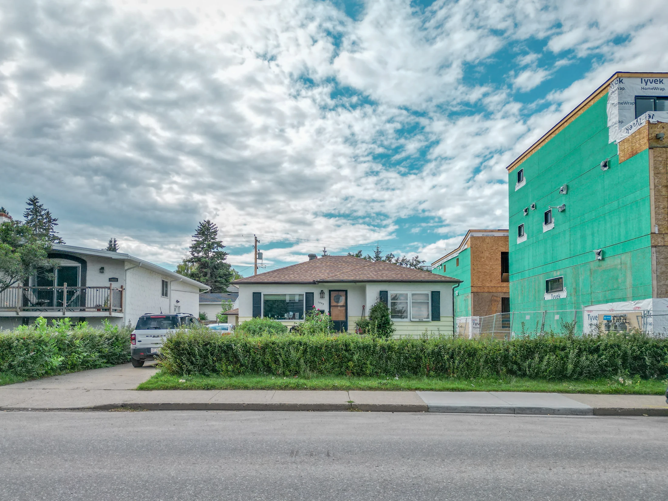 Older bungalow beside a new infill under construction
