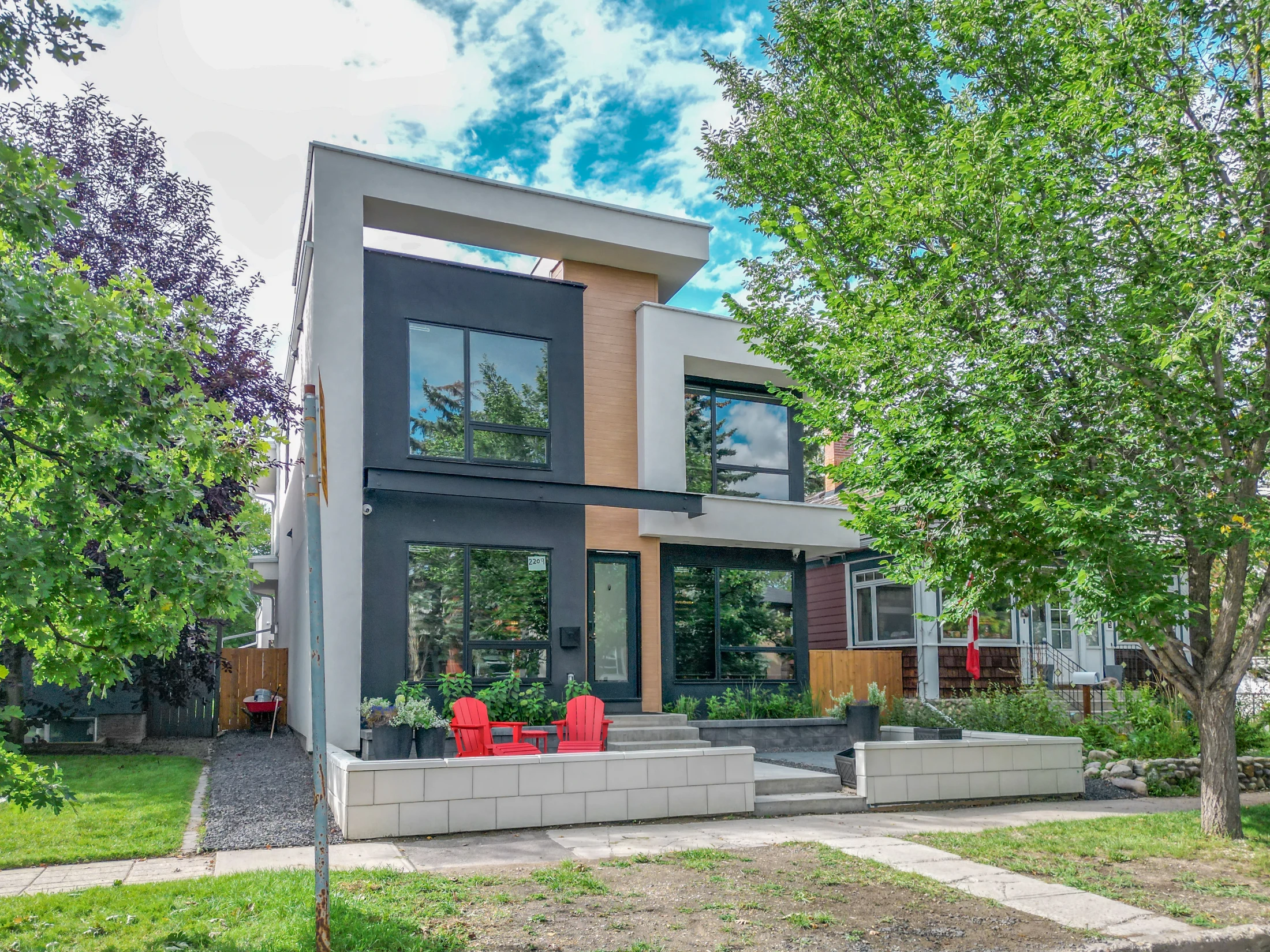 Modern infill home with large windows and a front patio