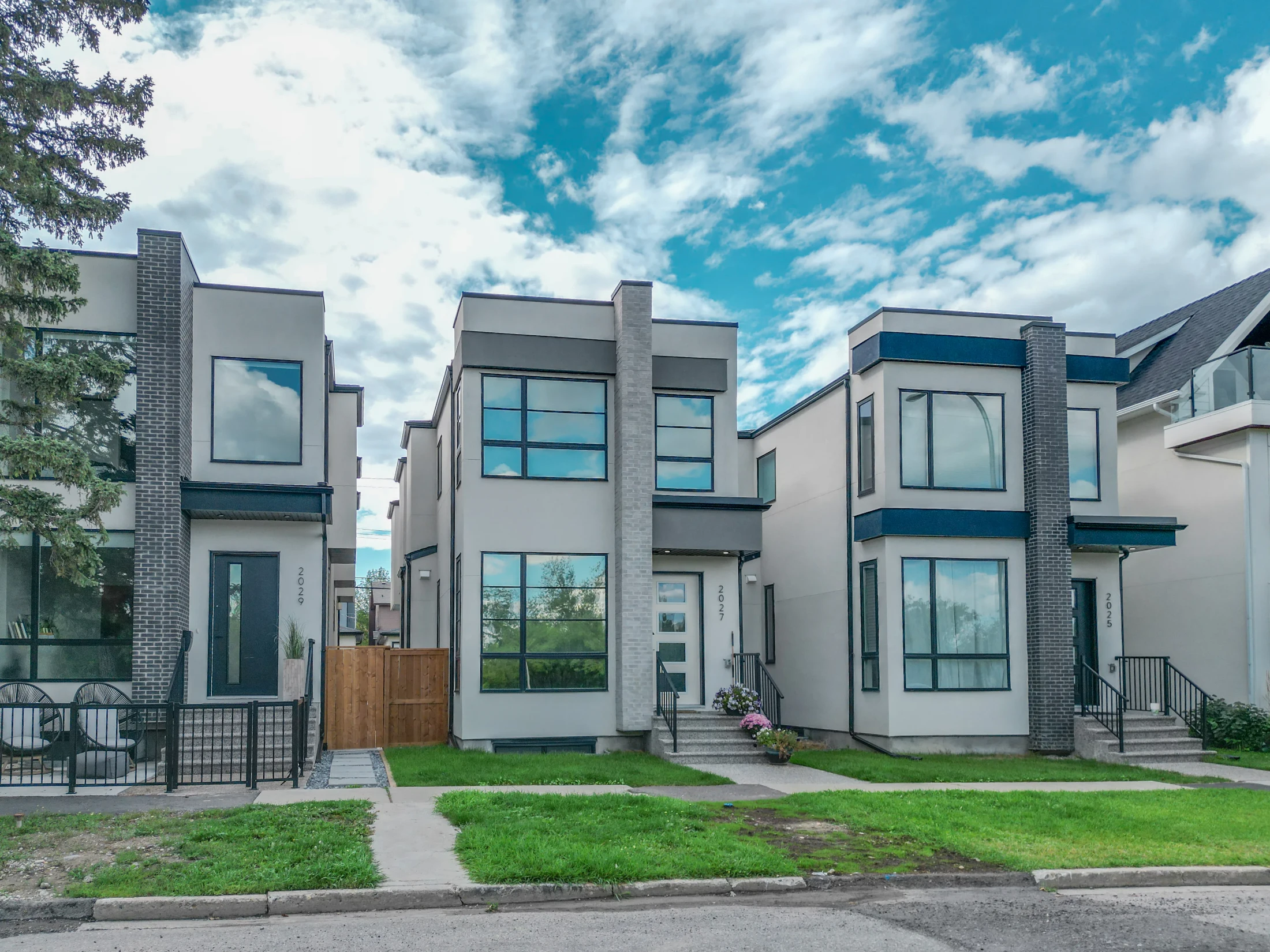 Modern narrow infill homes side by side on an inner-city street