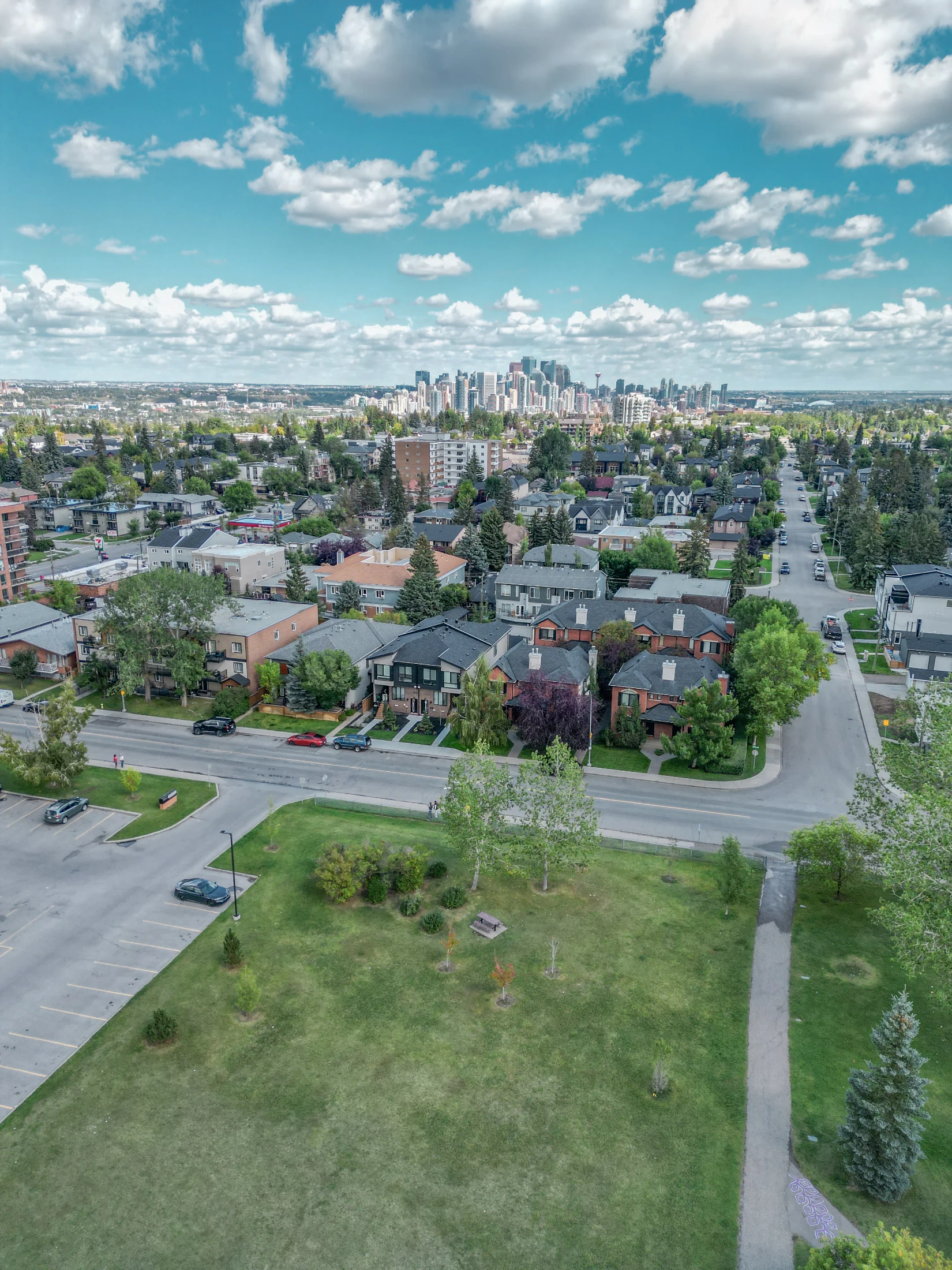 Aerial of an inner-city neighbourhood with condos, infills and the downtown skyline