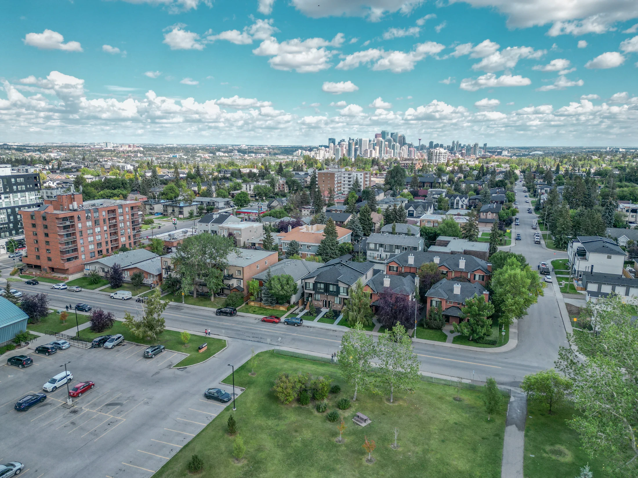 Aerial of an inner-city neighbourhood with infills and the downtown skyline