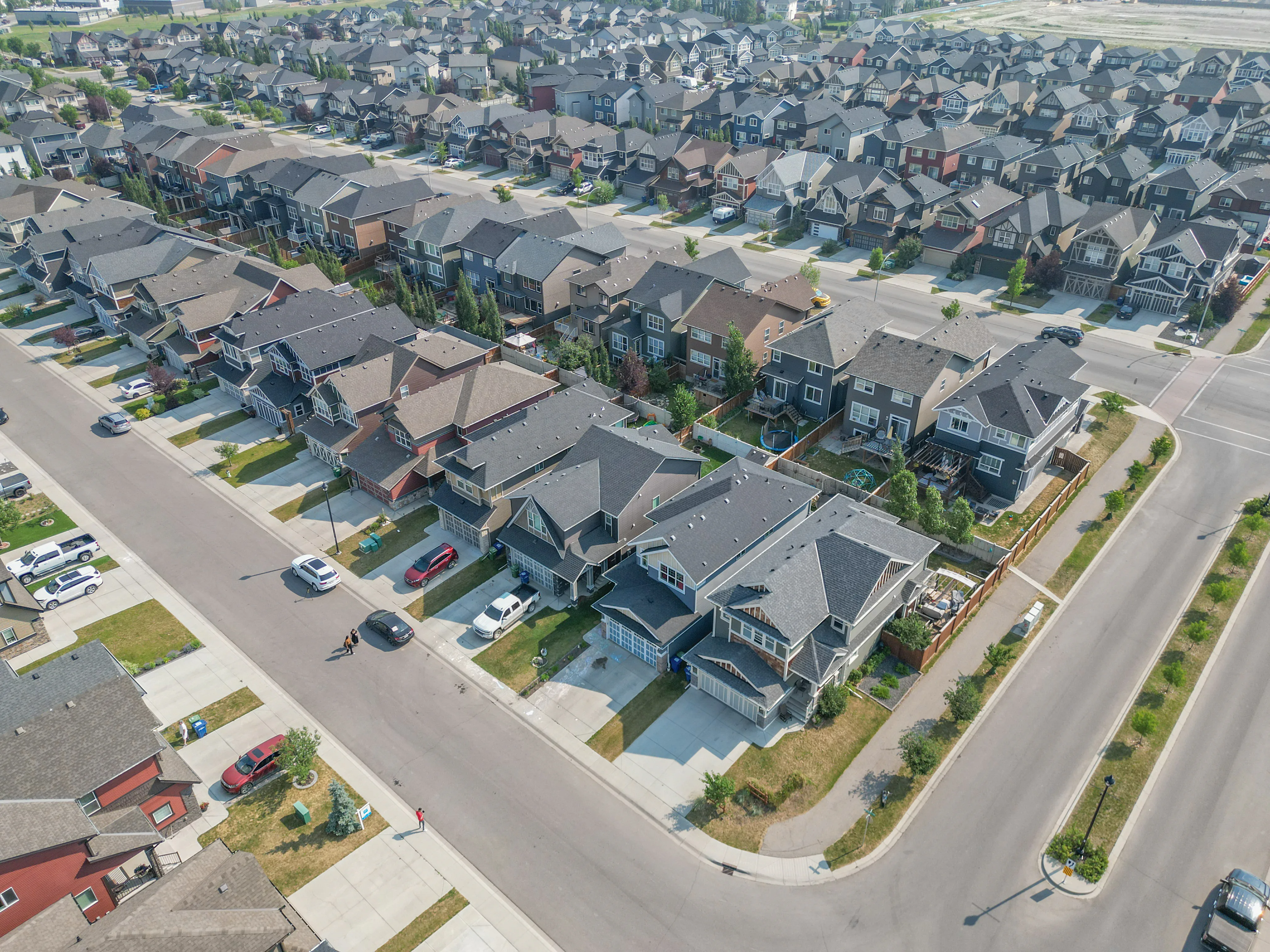 Aerial of a row of two-storey homes with front garages