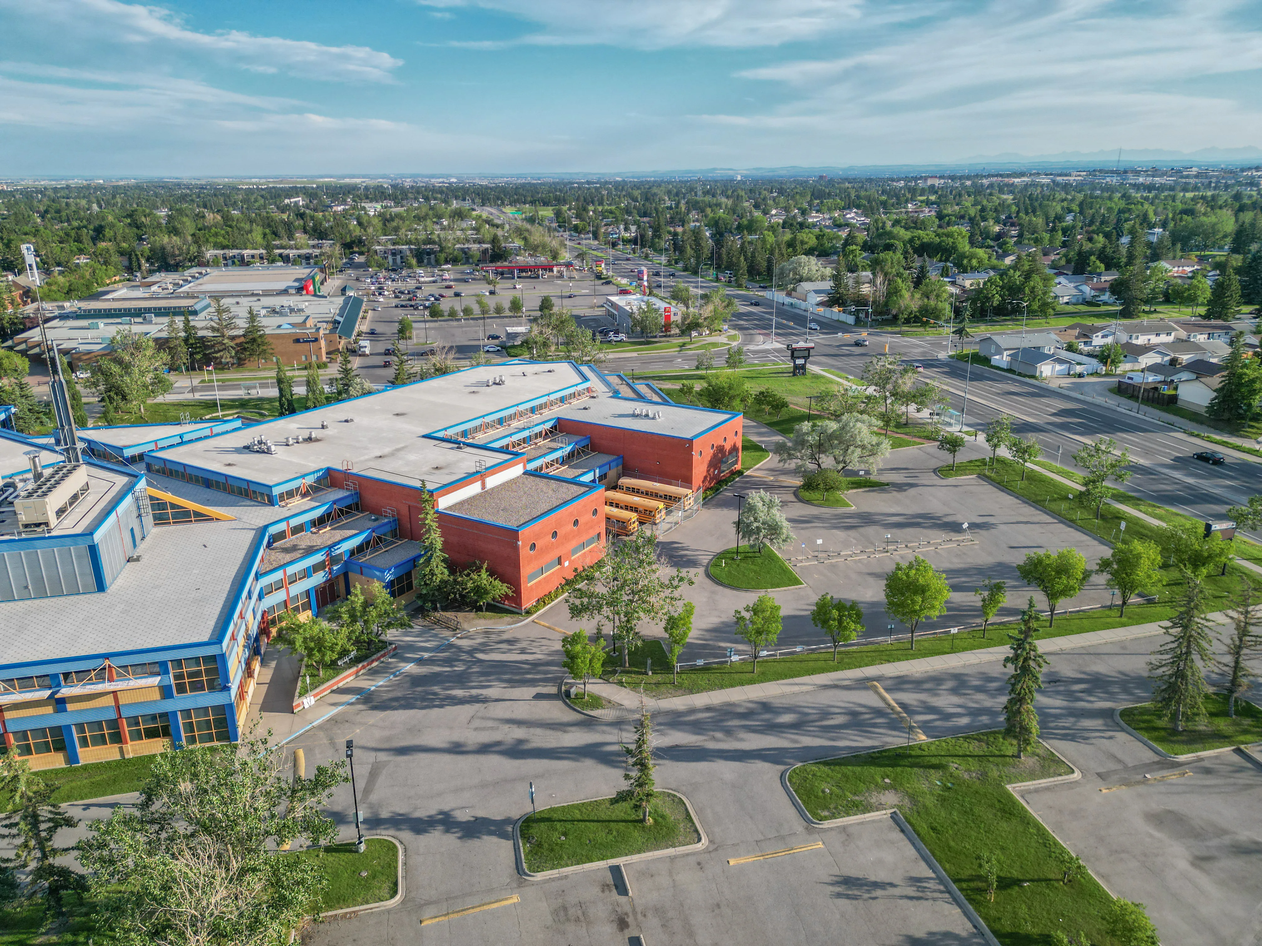 Aerial of a school with playing fields and tree-lined streets
