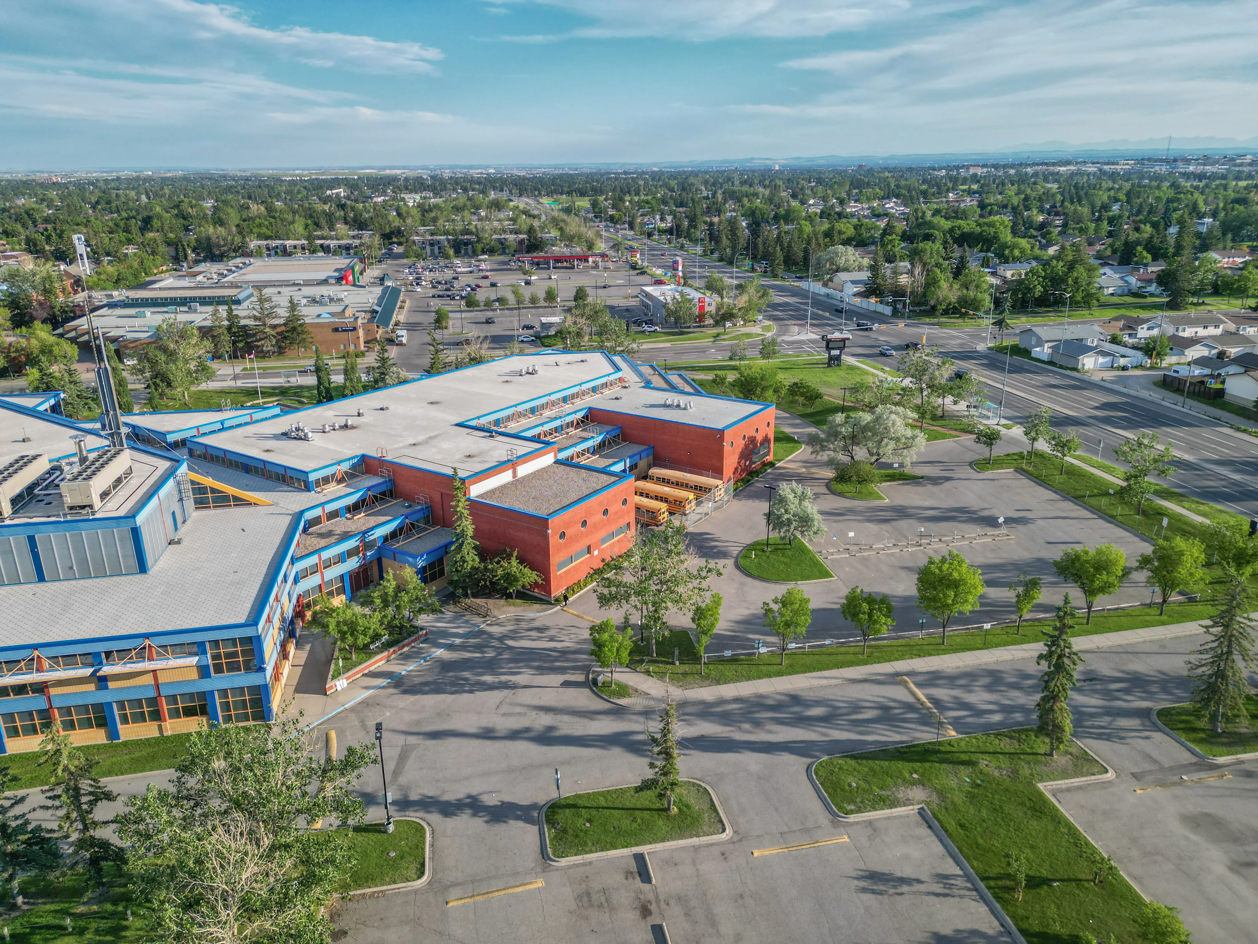 Aerial of a school with sports fields and mature trees