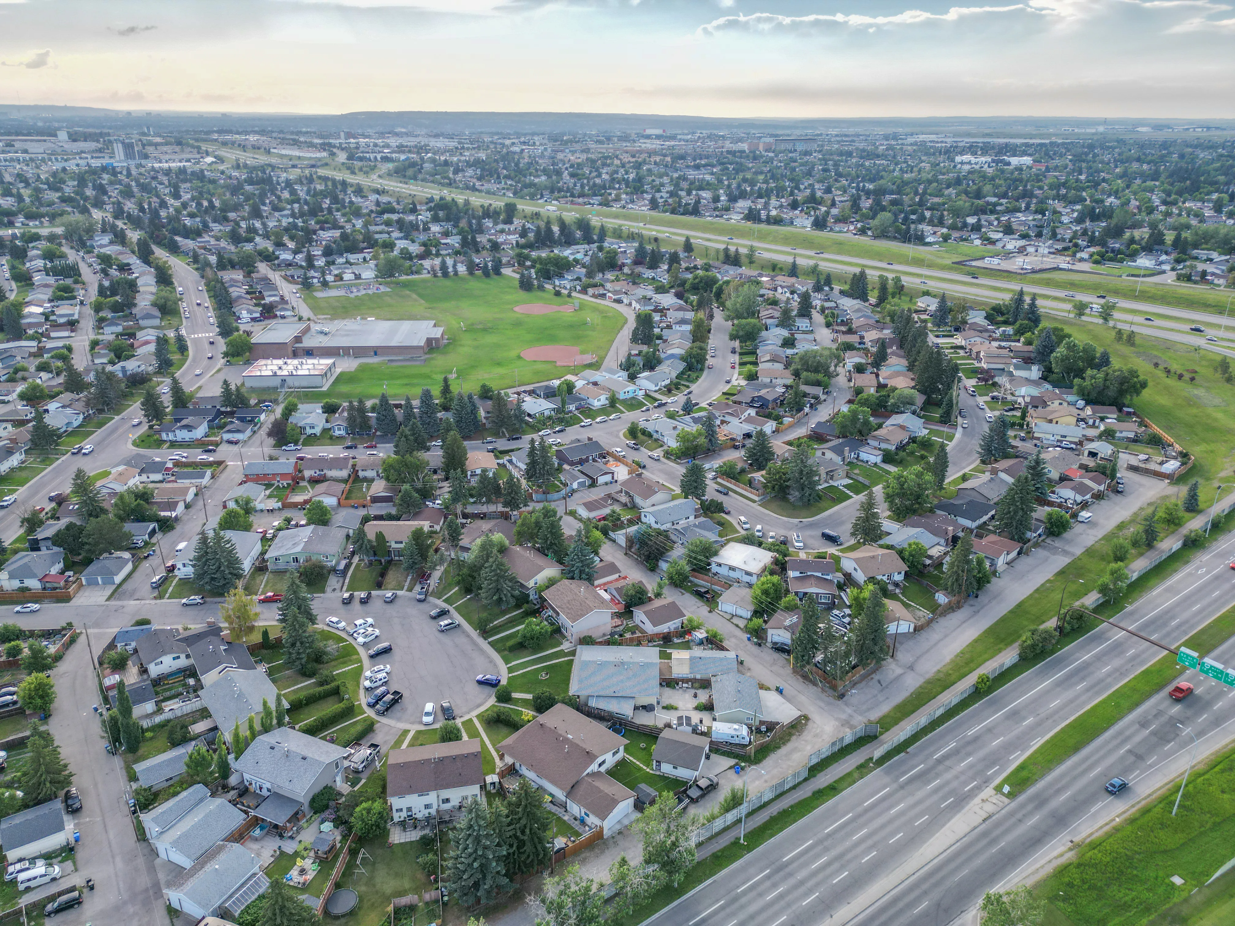 Aerial of a park with a sports field surrounded by homes