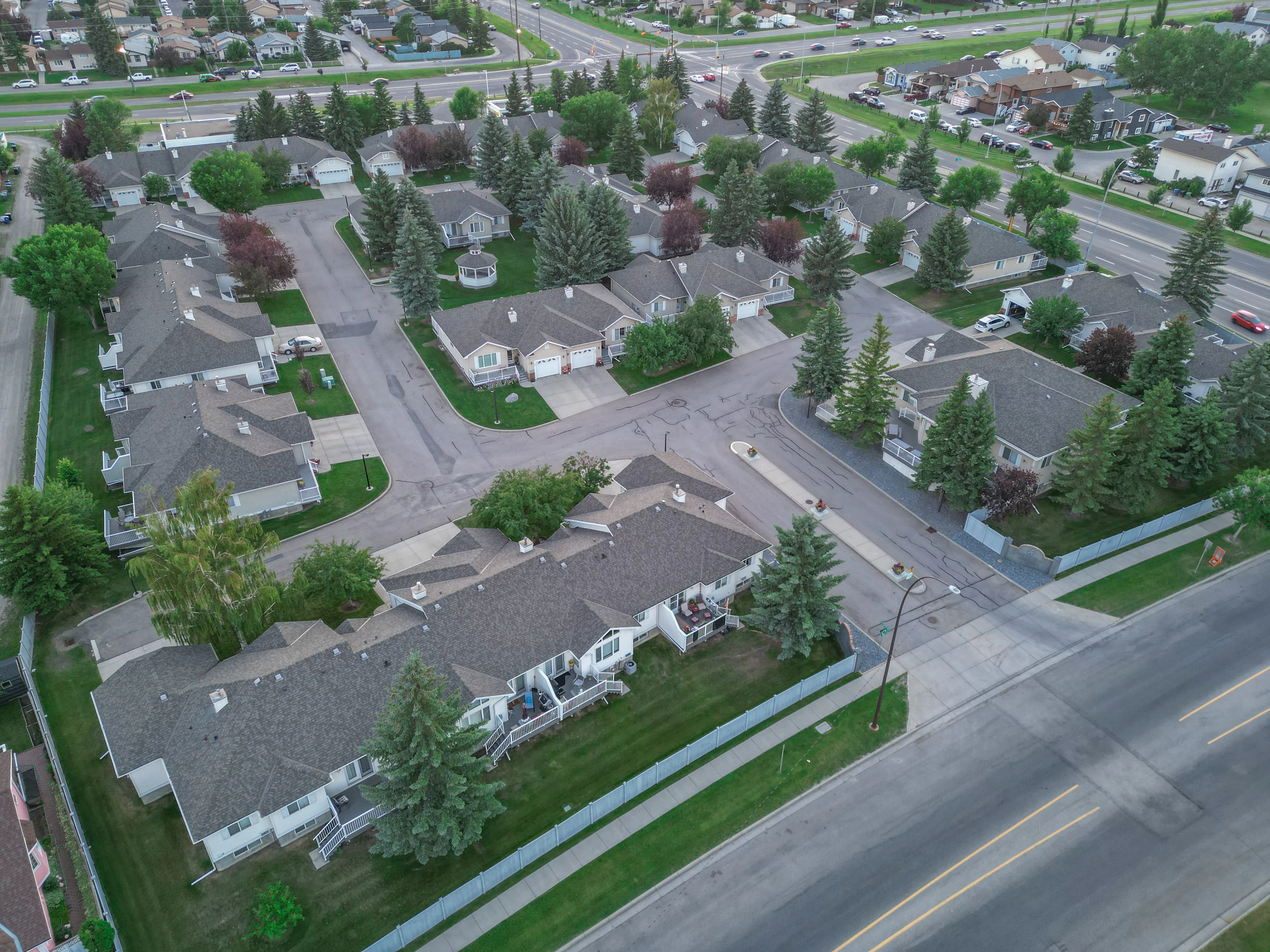 Aerial of a townhouse complex with mature trees