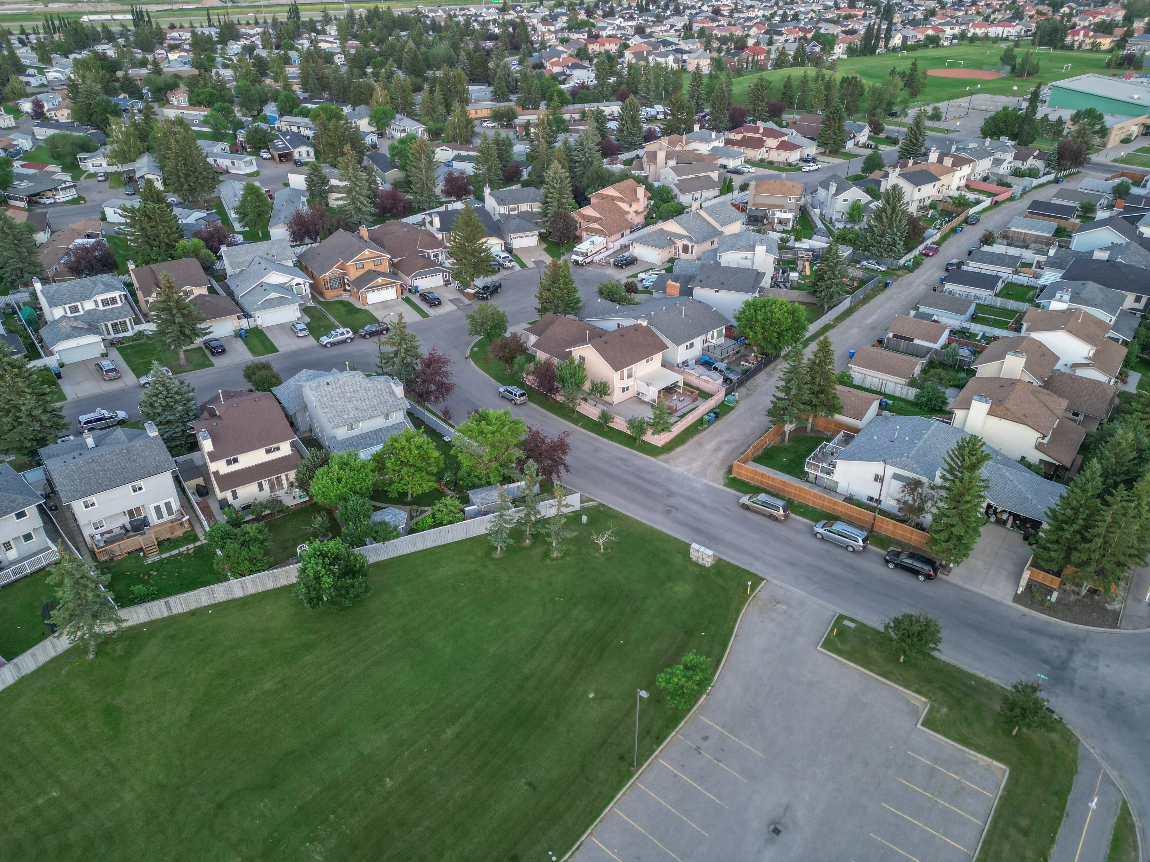 Aerial of homes around a small park with trees